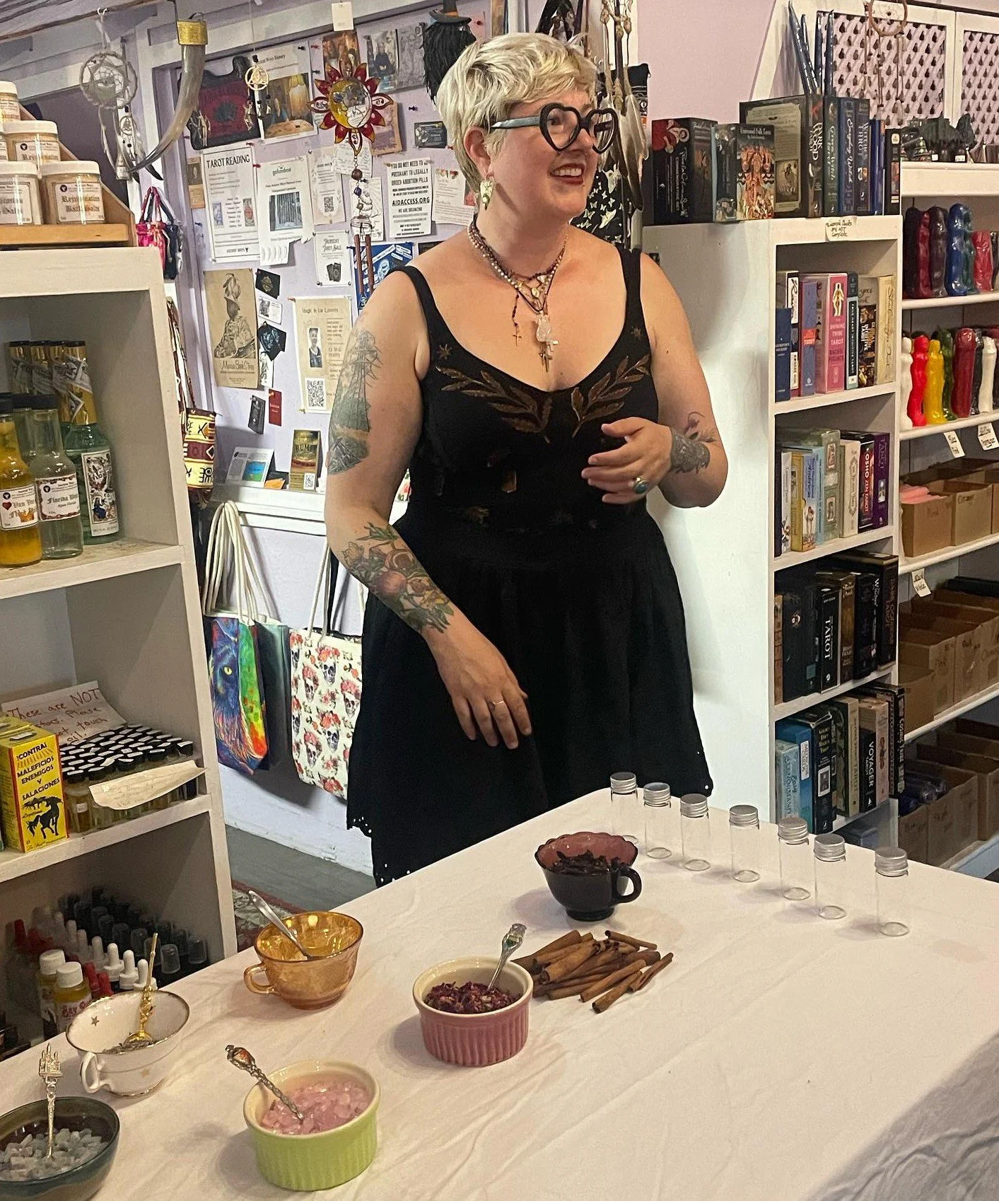 Lauren Parker 40 spells success standing with table and retail.JPG