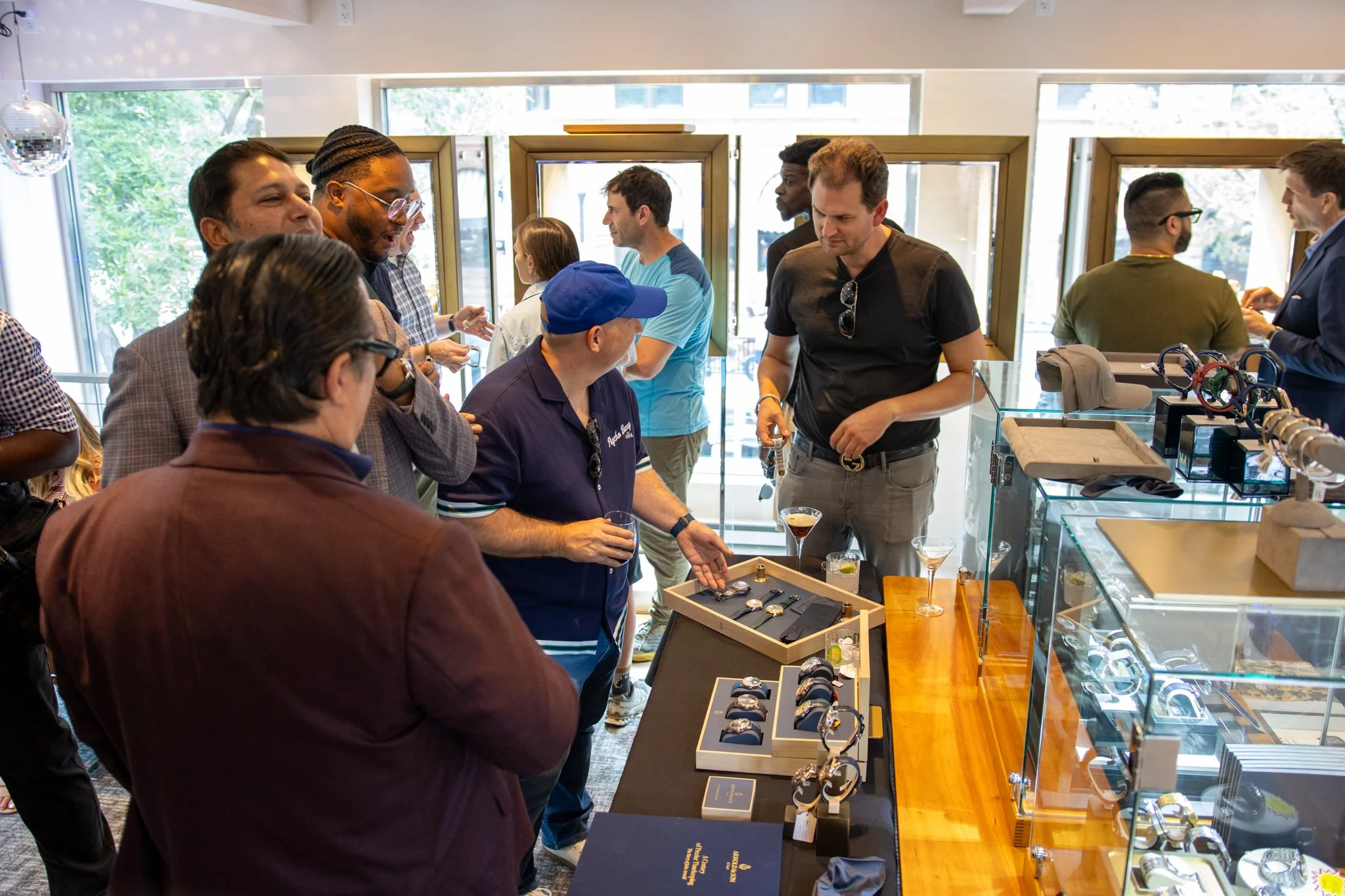 Group of people at a jewelry store shopping for watches and accessories.
