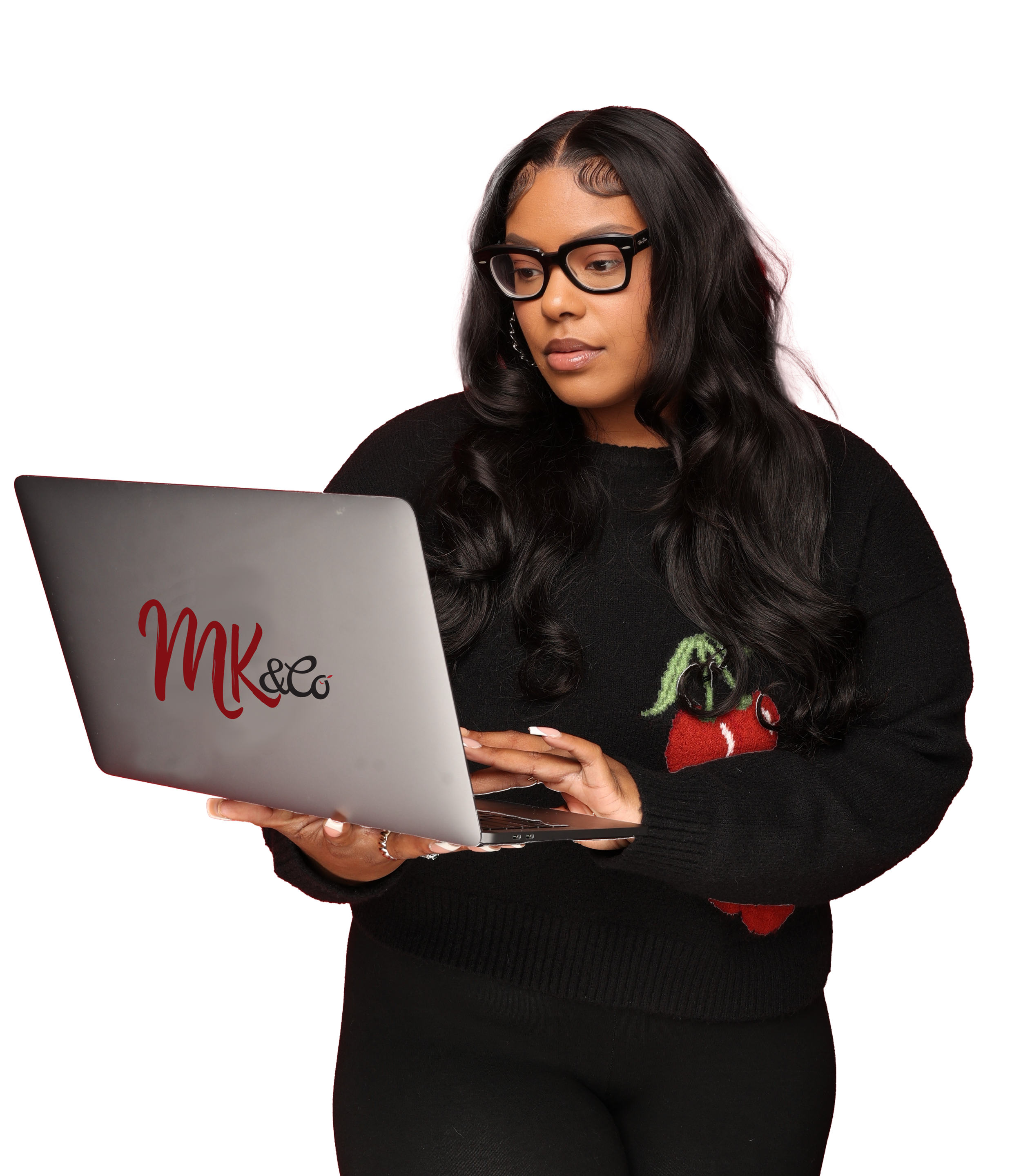 Monét Miller holding a laptop that says MK&Co working on marketing
