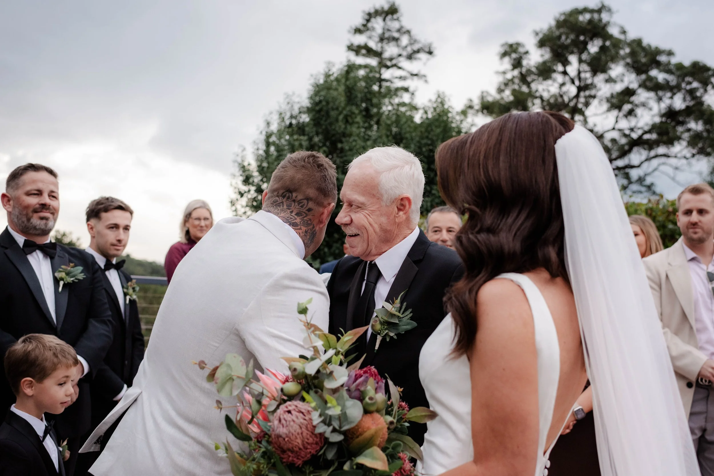 Groom shaking hands with father of the bride at the wedding ceremony altar at Jason's Restaurant Beaconsfield Victoria