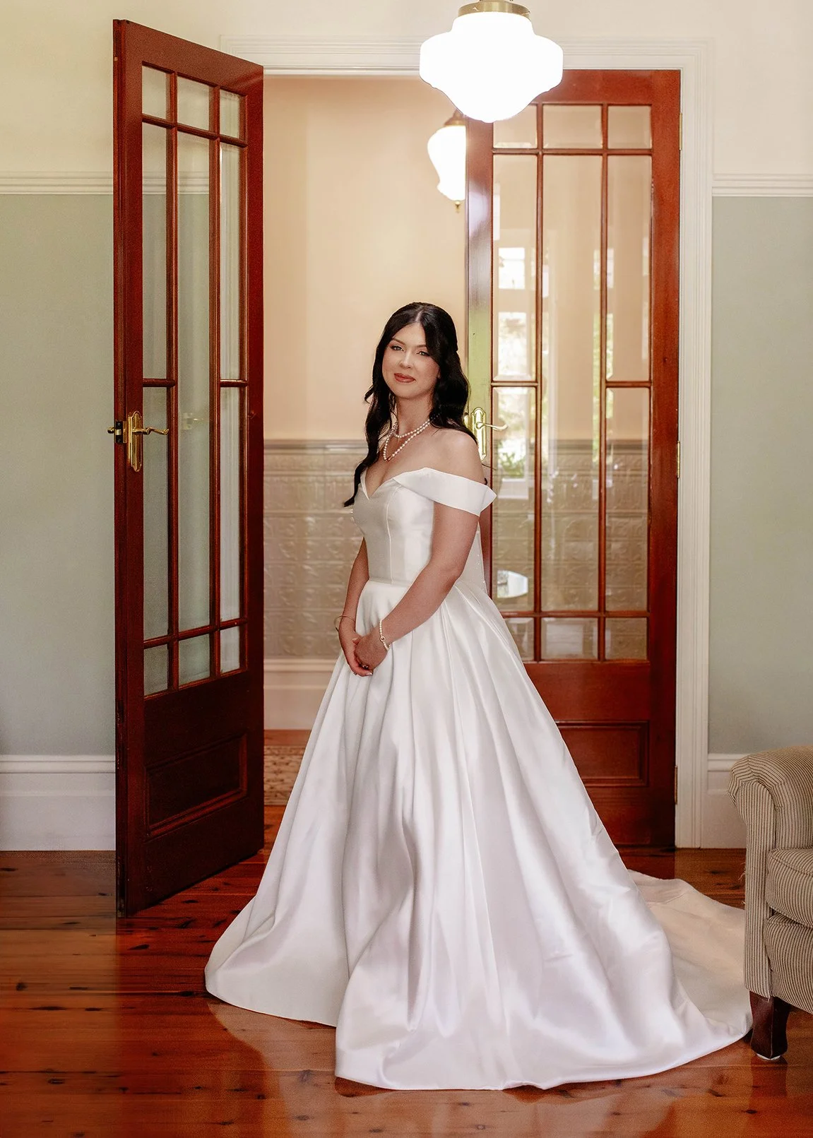 bride-poses-wooden-door-wedding-dress.jpg