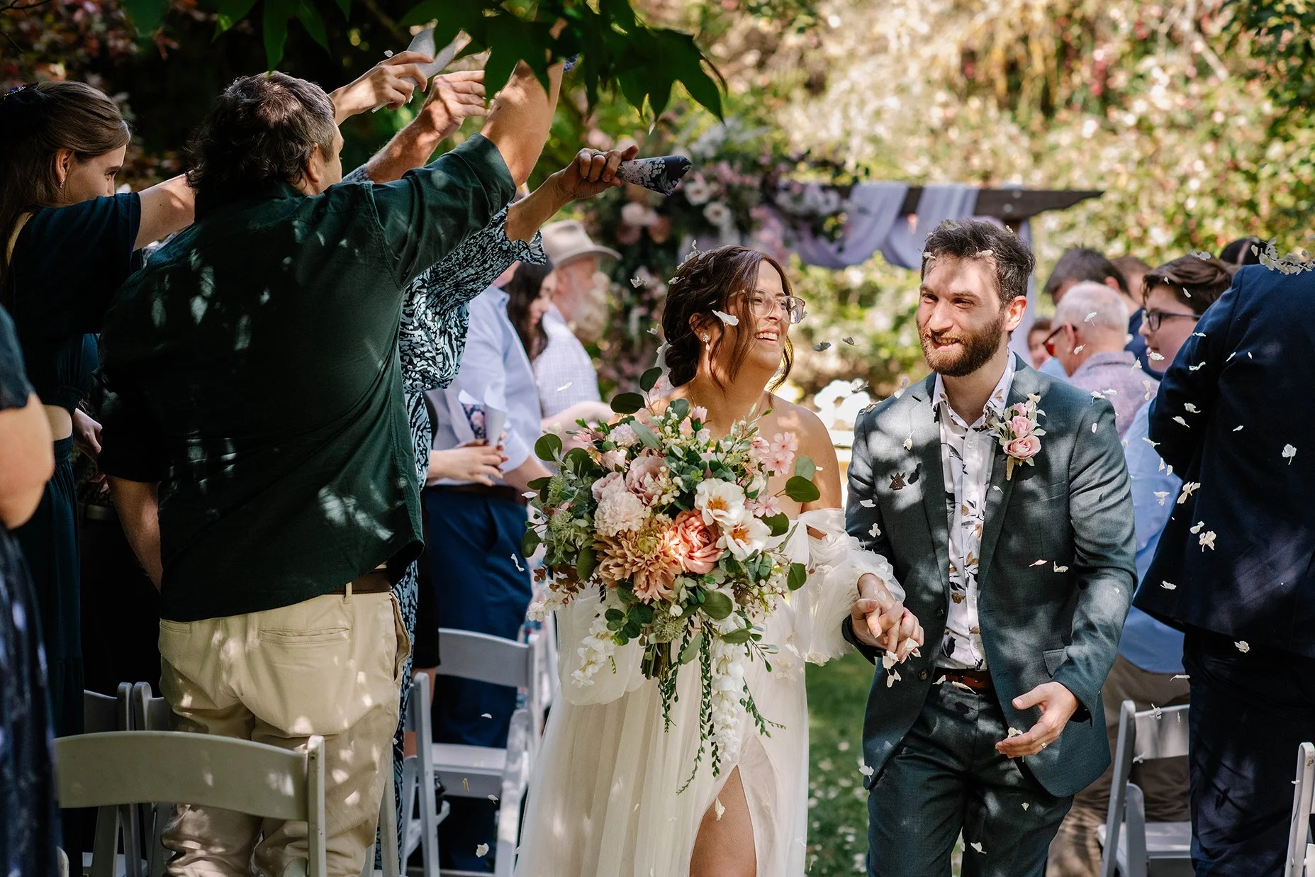 Bride and groom petal exit through garden in Bendigo