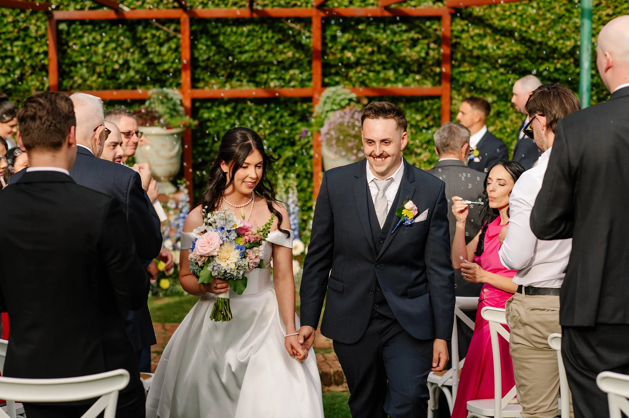 bride-groom-together-exit-aisle-bubbles-olinda.jpg