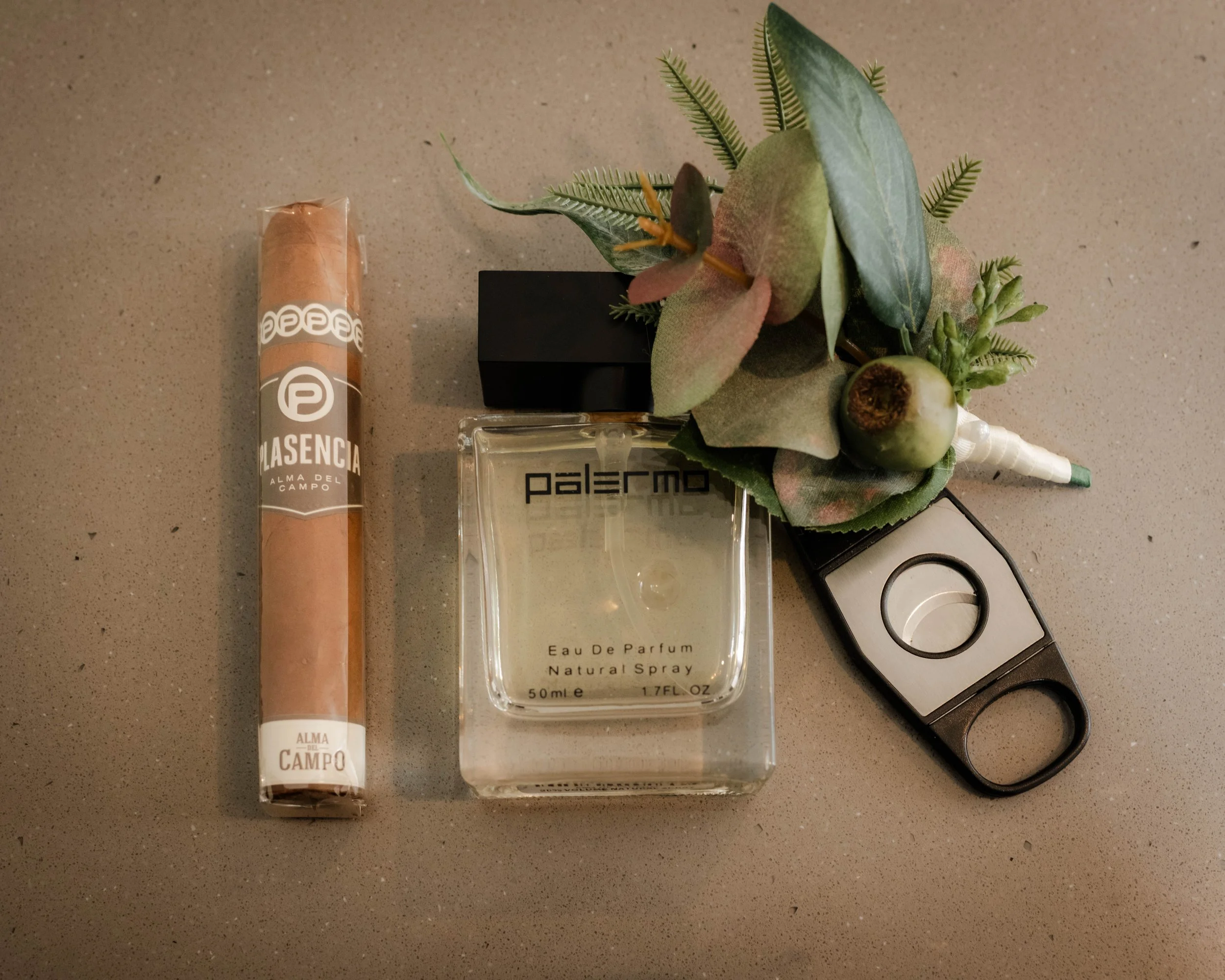 Groom's wedding day flat lay with cigar, cologne and boutonniere at Jason's Restaurant Beaconsfield wedding