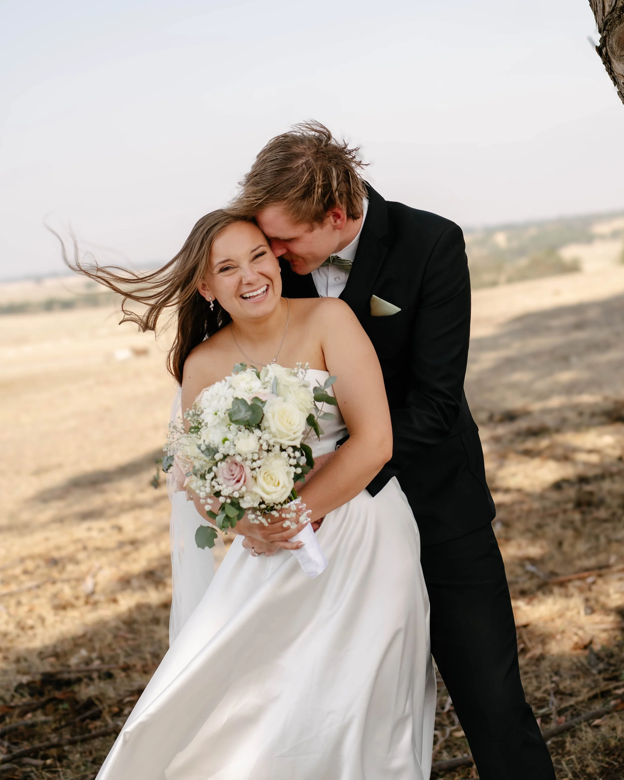 ballarat-bride-laughs-groom-whispers-ear.jpg
