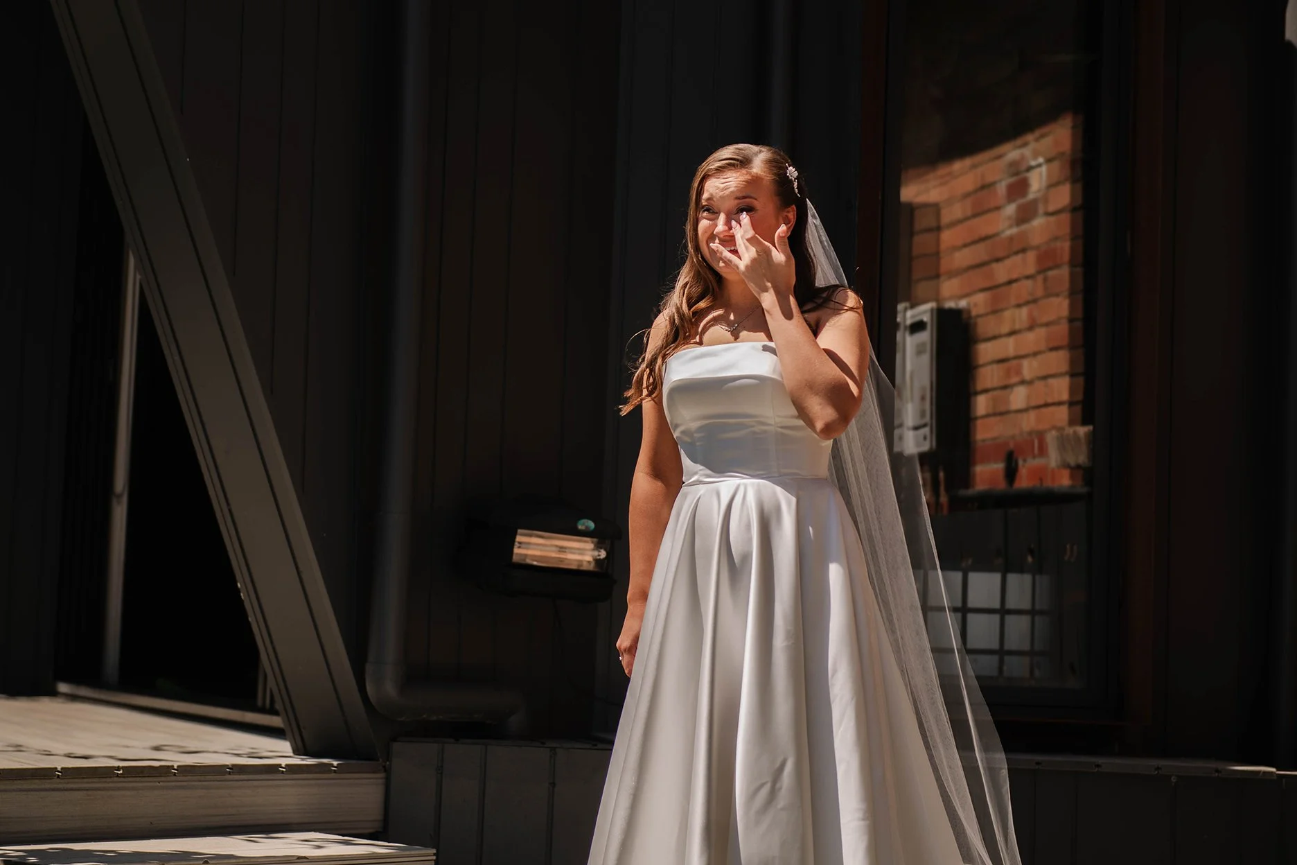 Bride standing and crying at her Ballarat house after first look with father