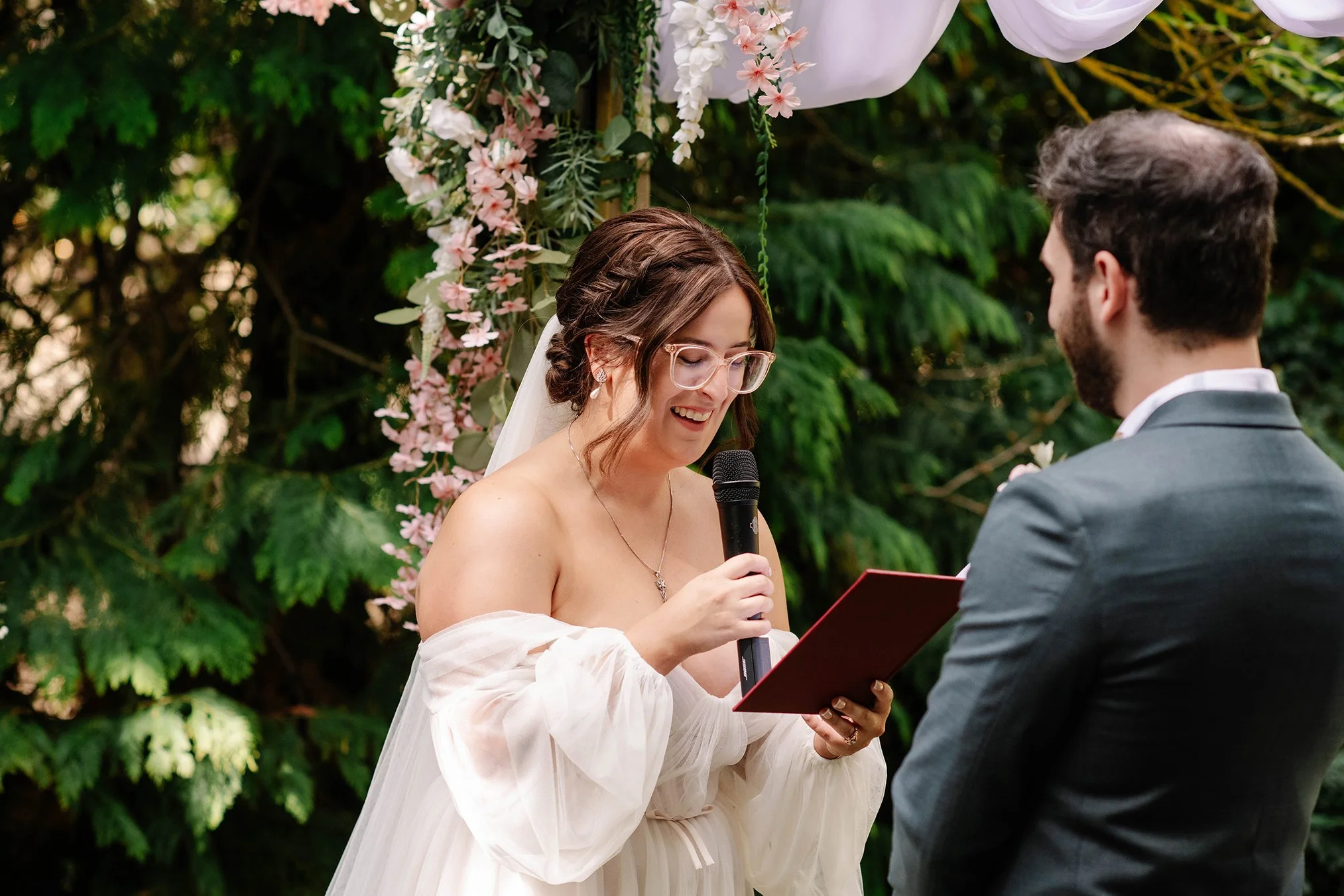 Bride smiles and reads vows in Bendigo garden venue