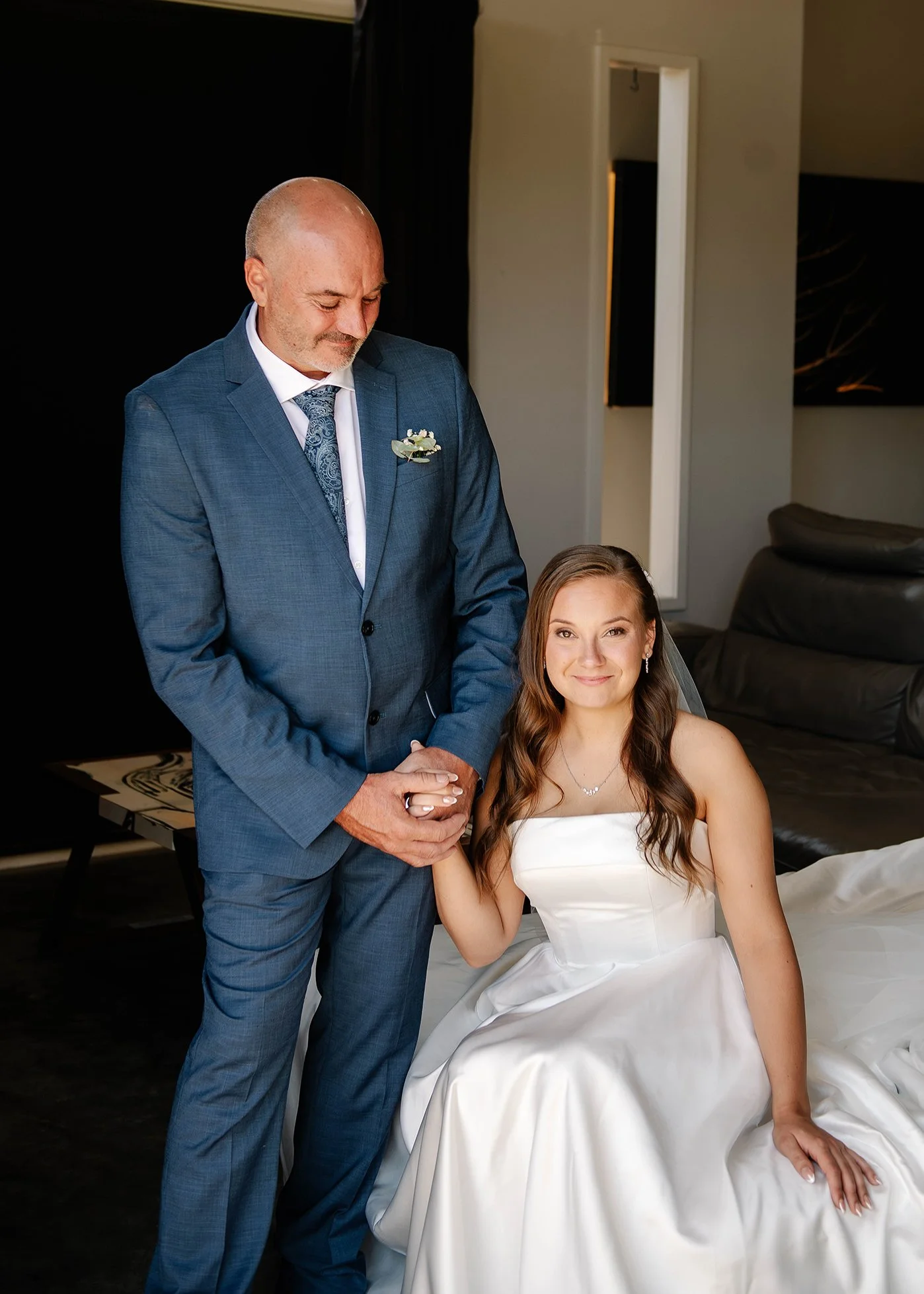 Brides father looks down at his daughter in their Ballarat house and smiles