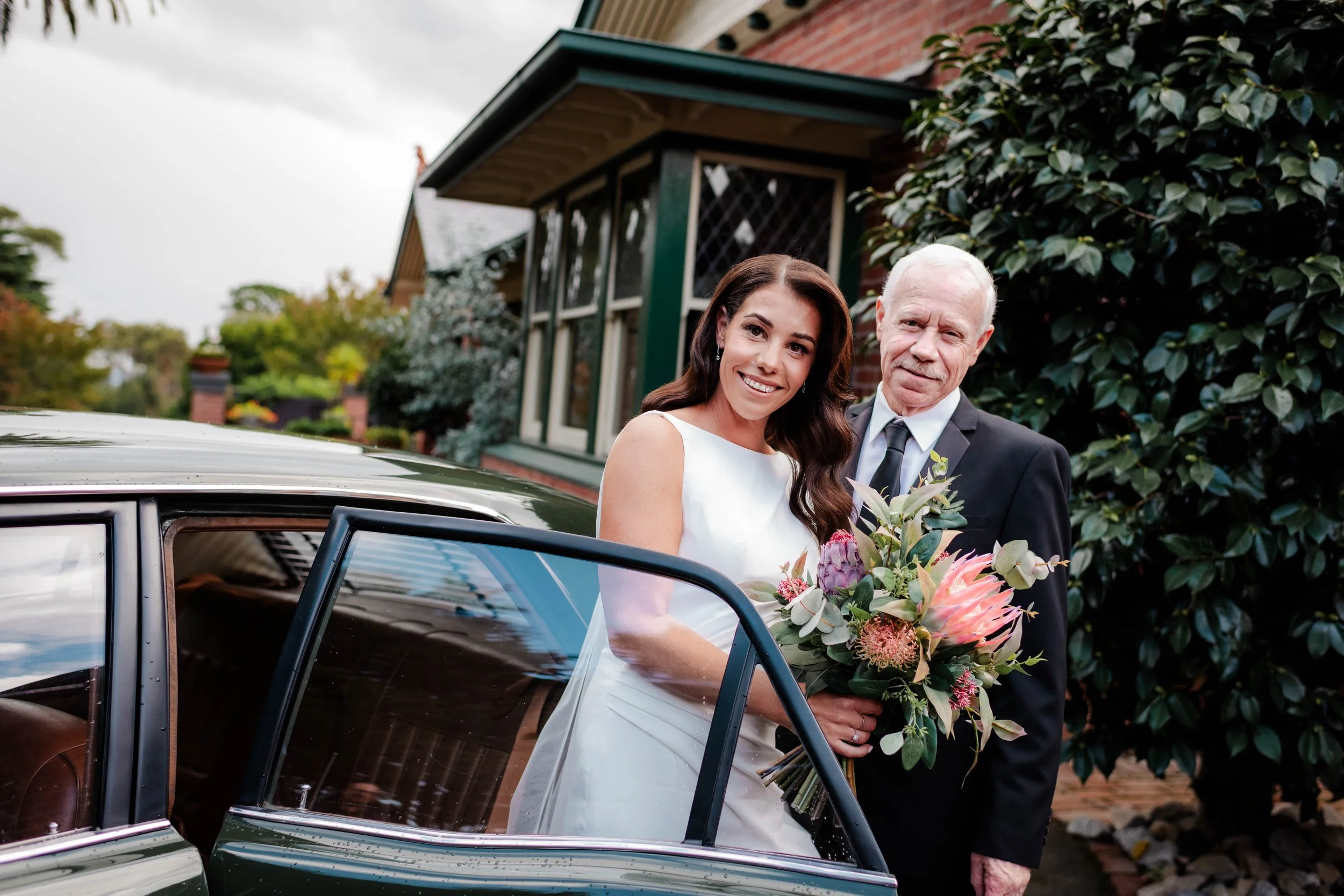 Bride and her father standing beside a vintage wedding car outside Jason's Restaurant Beaconsfield before the ceremony