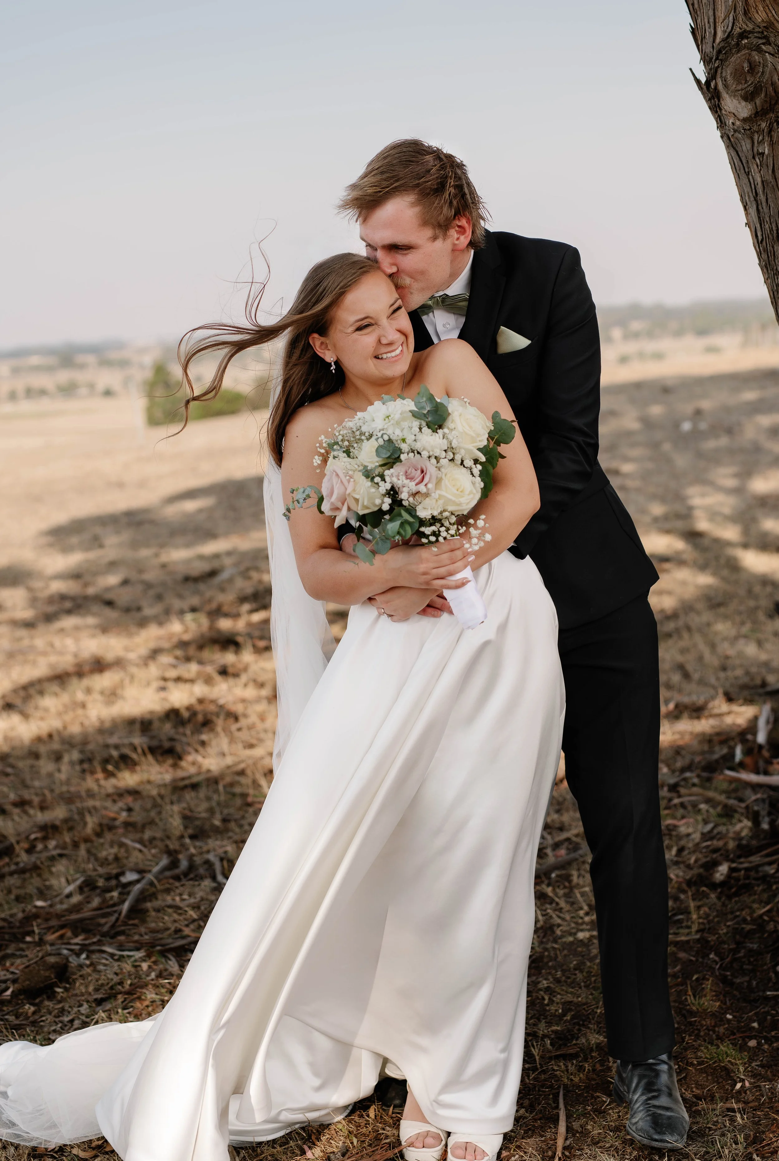 melbourne-wedding-photographer-ballarat-groom-kisses-smiling-brides-cheek.jpg