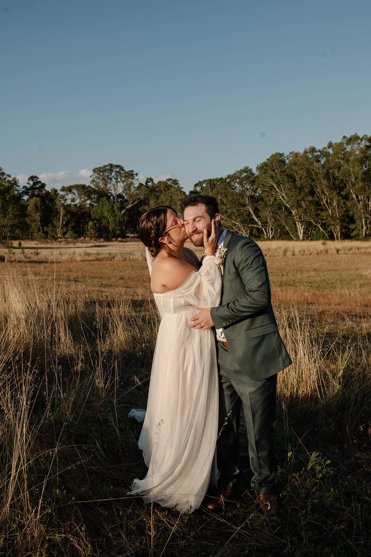 bride-kisses-groom-cheek-sunset-bendigo.jpg