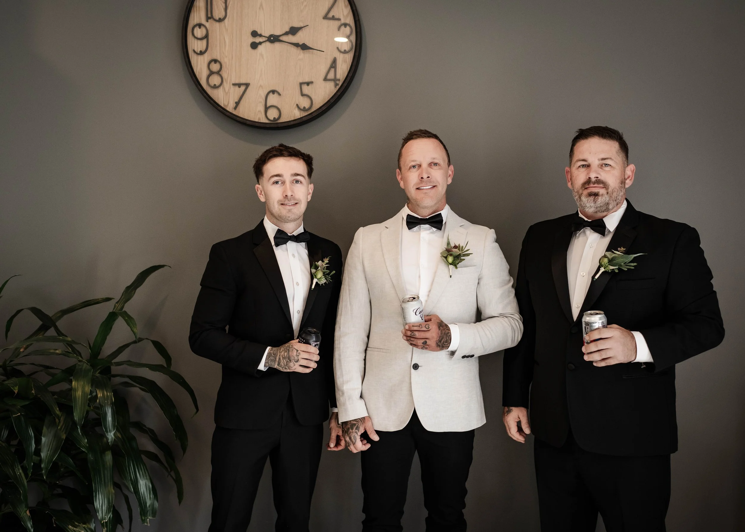 Groom and groomsmen in bow ties holding beers while getting ready at Jason's Restaurant Beaconsfield Victoria