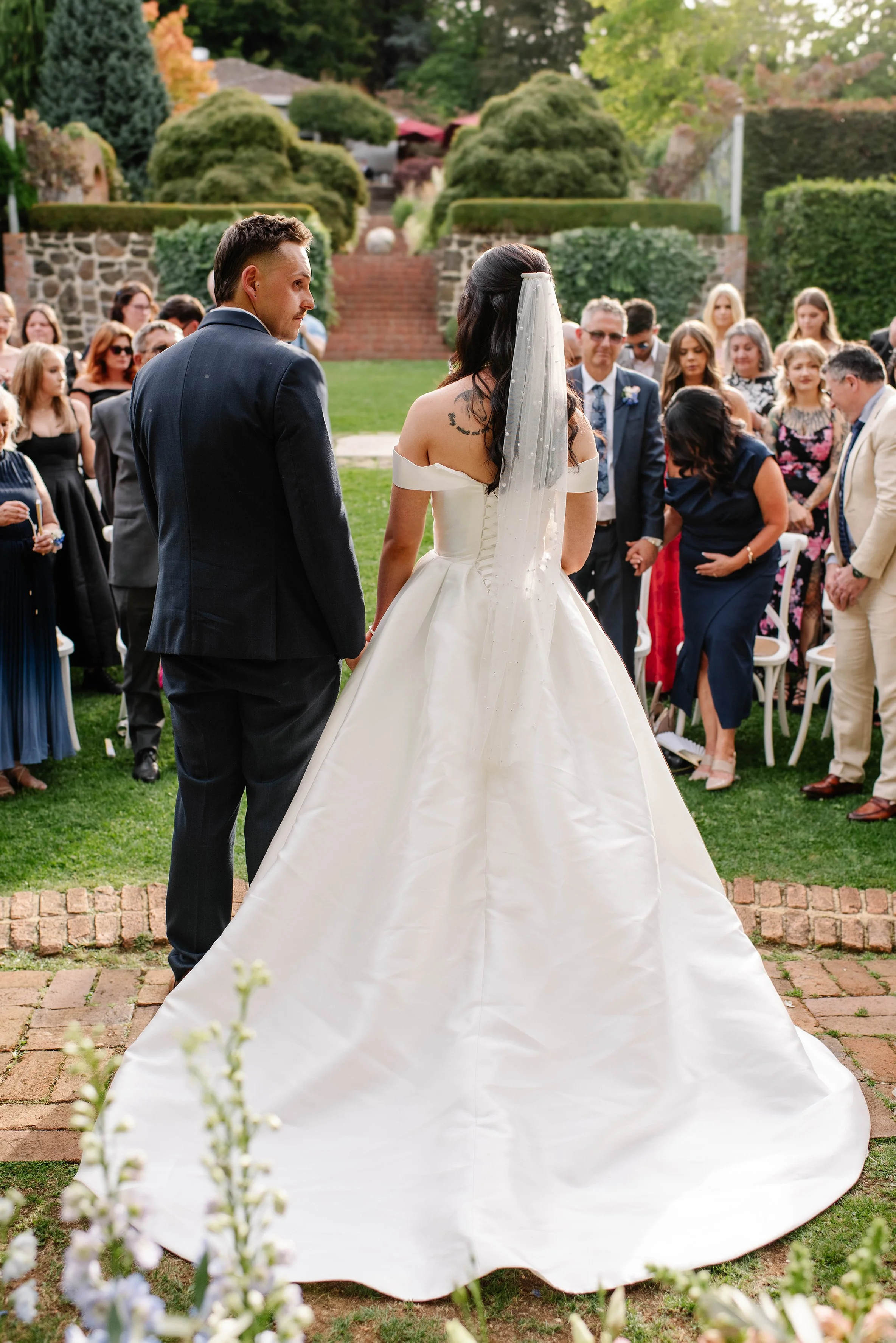 back-view-bride-groom-guests-behind-olinda.jpg