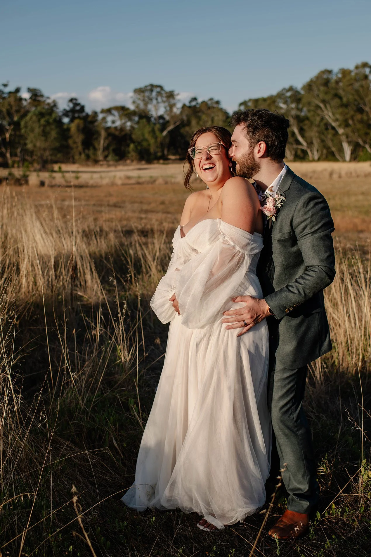 groom-whispers-bride-laughs-sunset-bendigo.jpg
