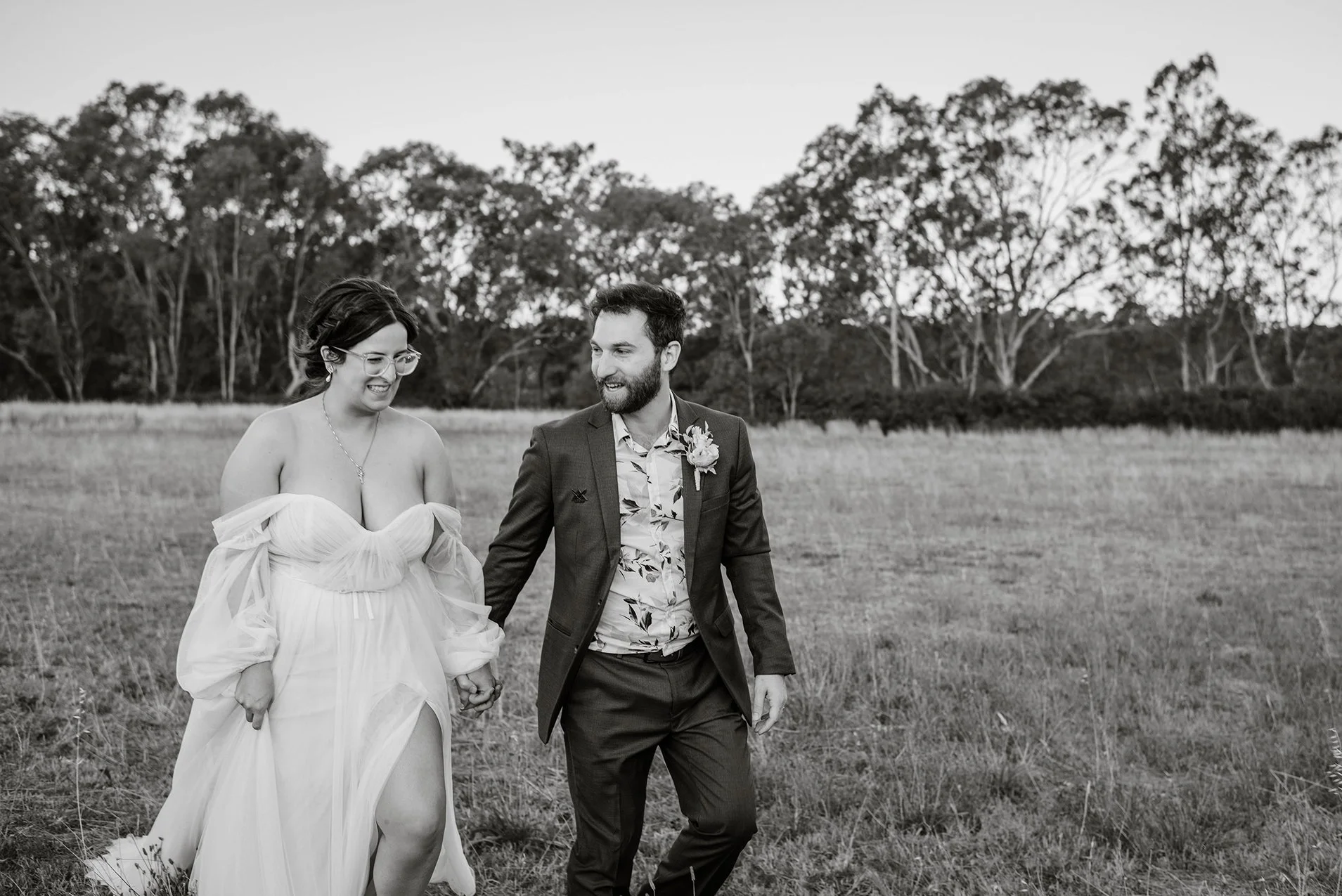 bride-groom-walk-black-white-chateau-dore-field.jpg