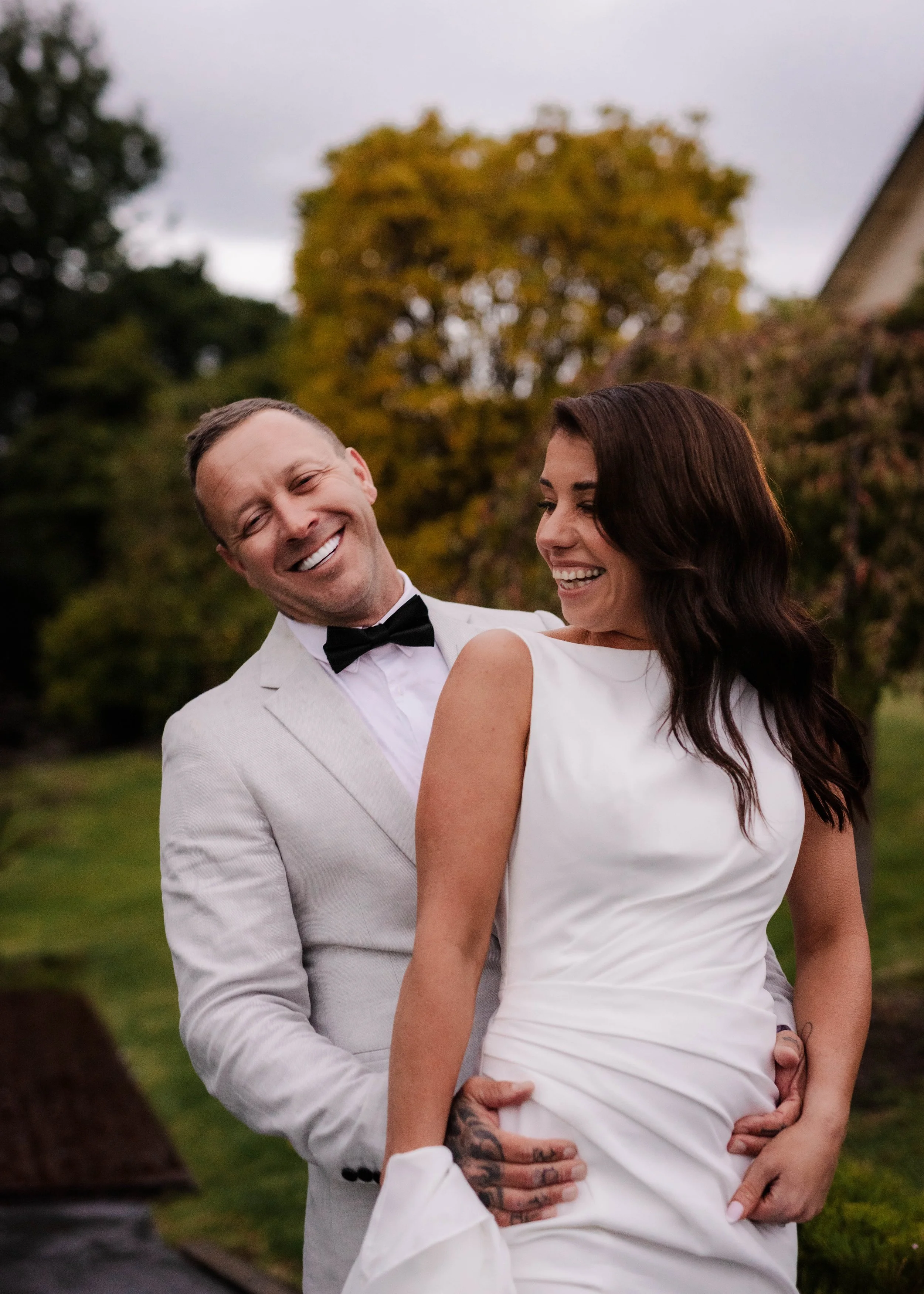 Bride and groom laughing together in the garden at Jason's Restaurant Beaconsfield wedding