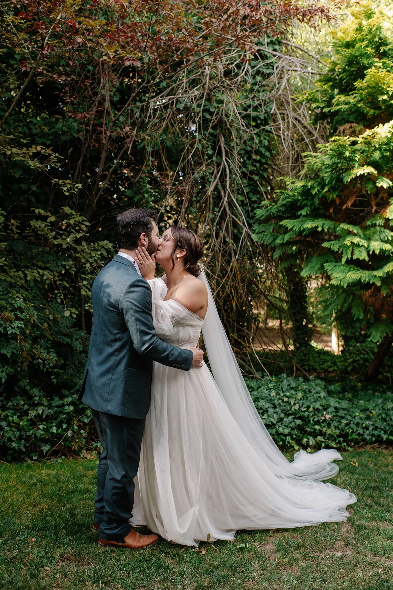 Romantic kiss in Chateau Dore garden by Chateau Dore wedding venue photographer