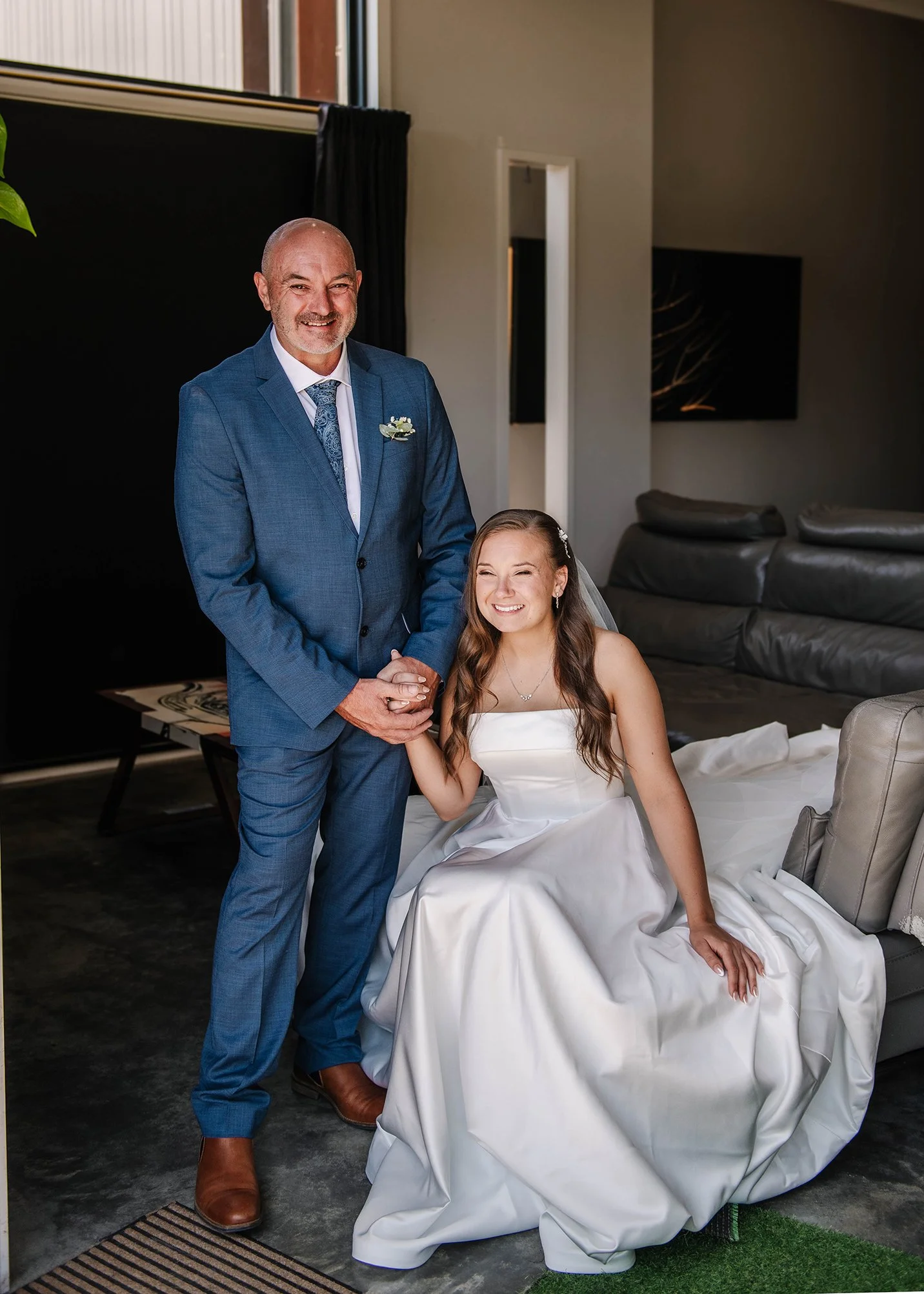 Father of the bride poses with his daughter inside their Ballarat house