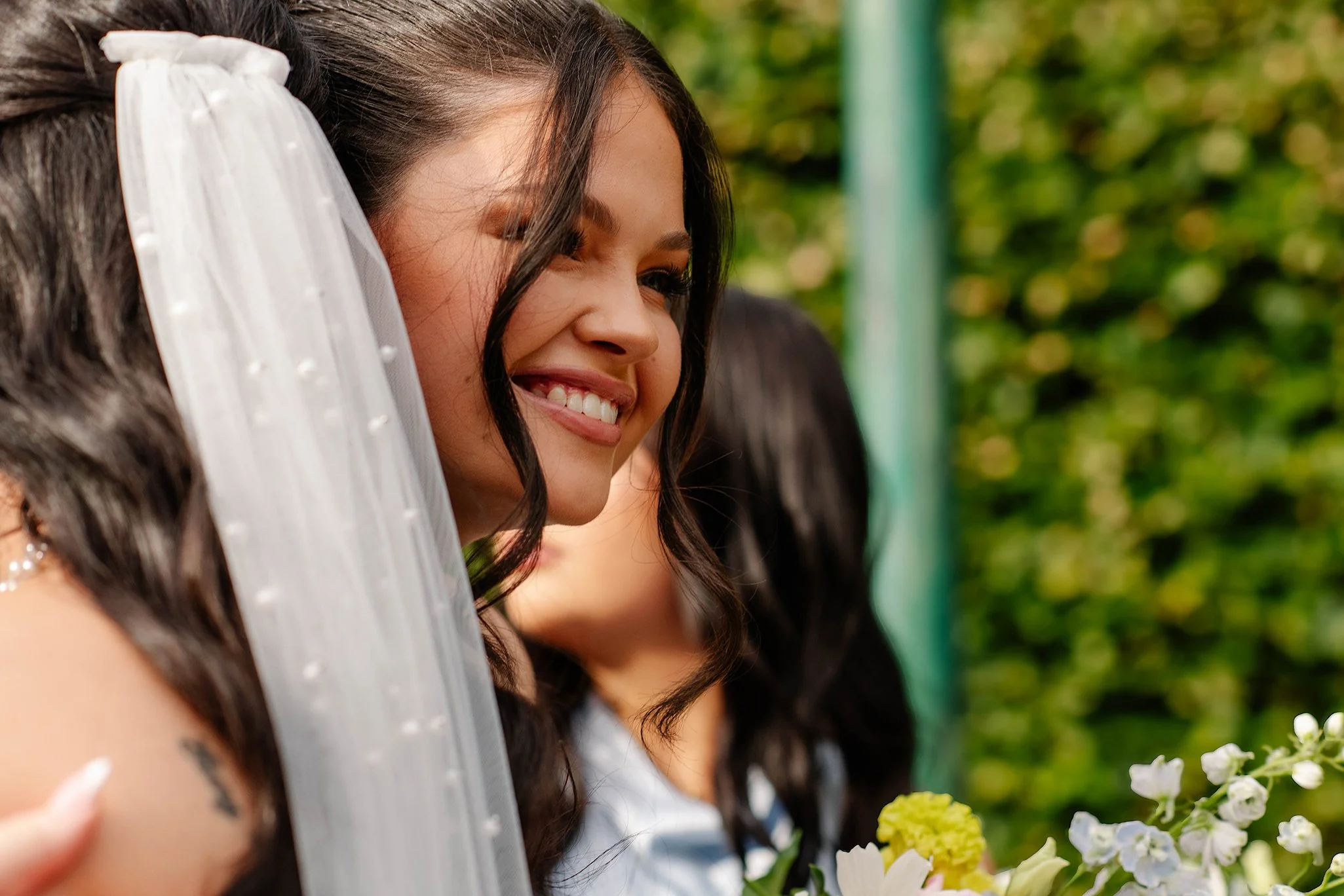 bridesmaid-embraces-brides-after-olinda-garden-wedding.jpg