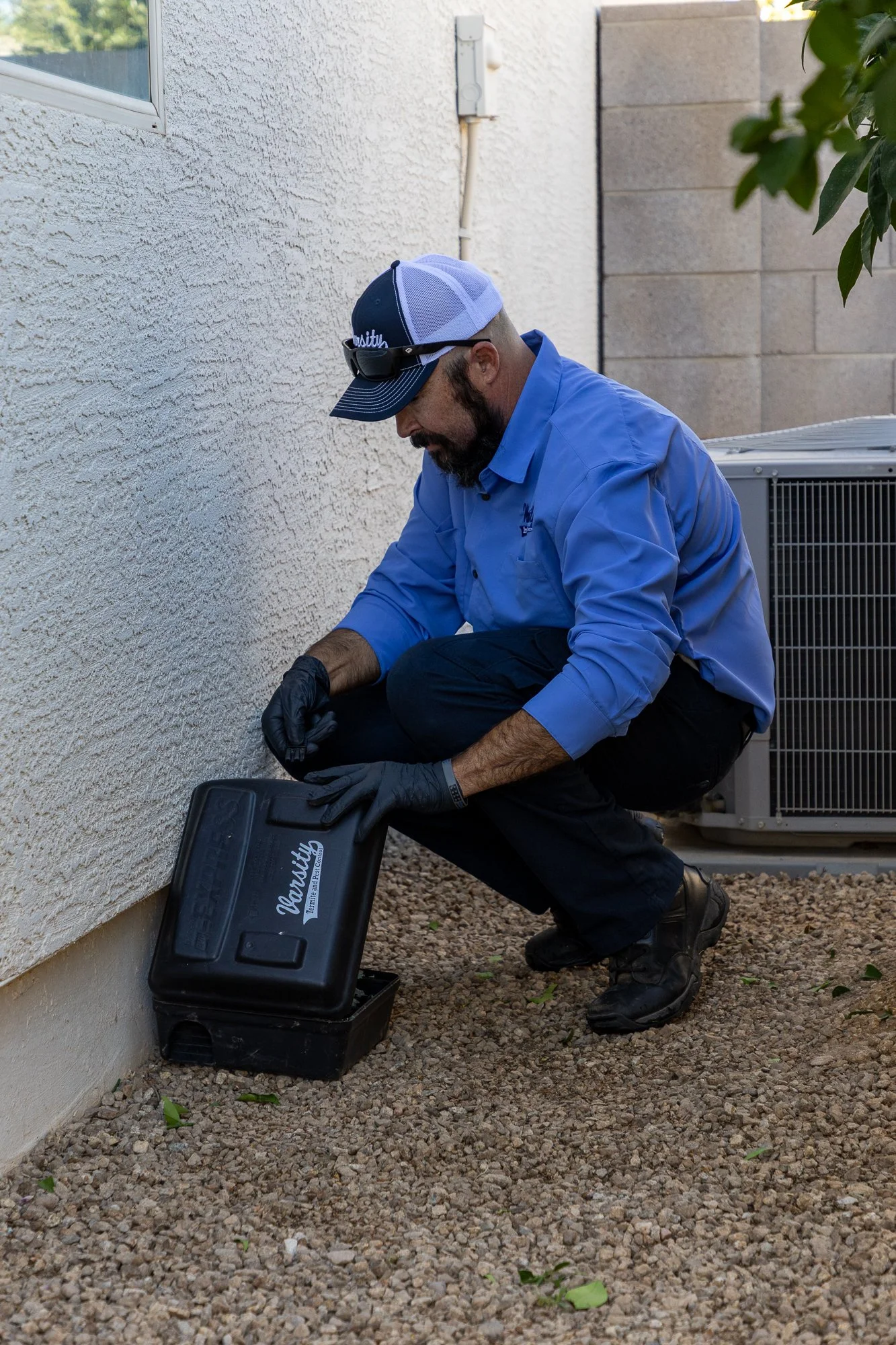 Varsity pest control man servicing business in Queen Creek, AZ