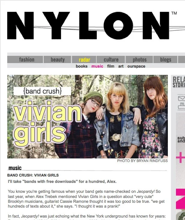 A webpage of Nylon magazine featuring an article about Vivian Girls, a band, with a photo of three young women outdoors in casual clothing.