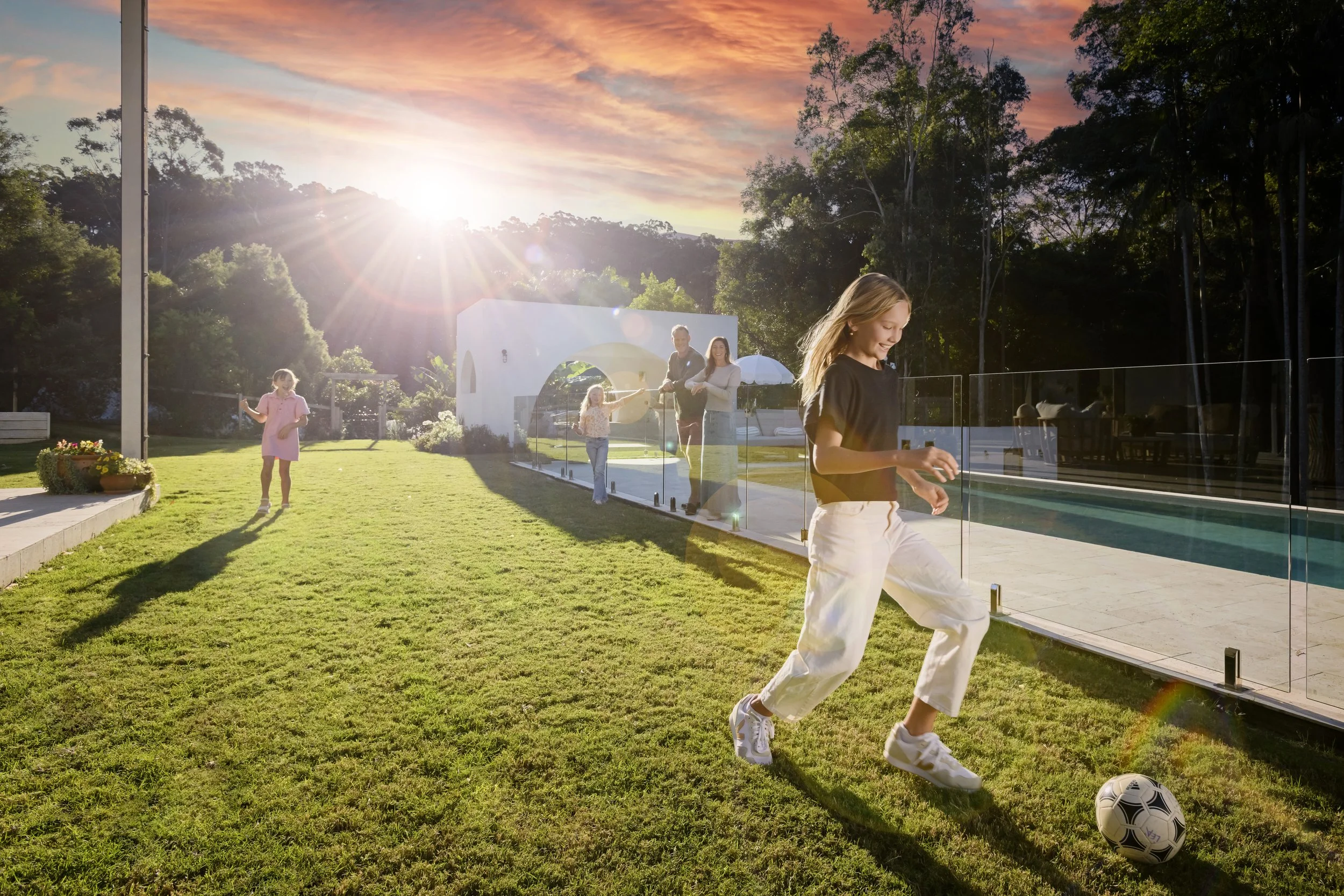 Girl kicking a soccer ball in a backyard in Brisbane