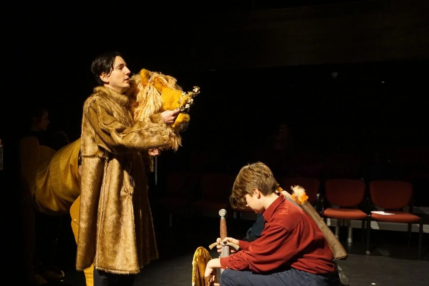 Man operating a lion puppet
