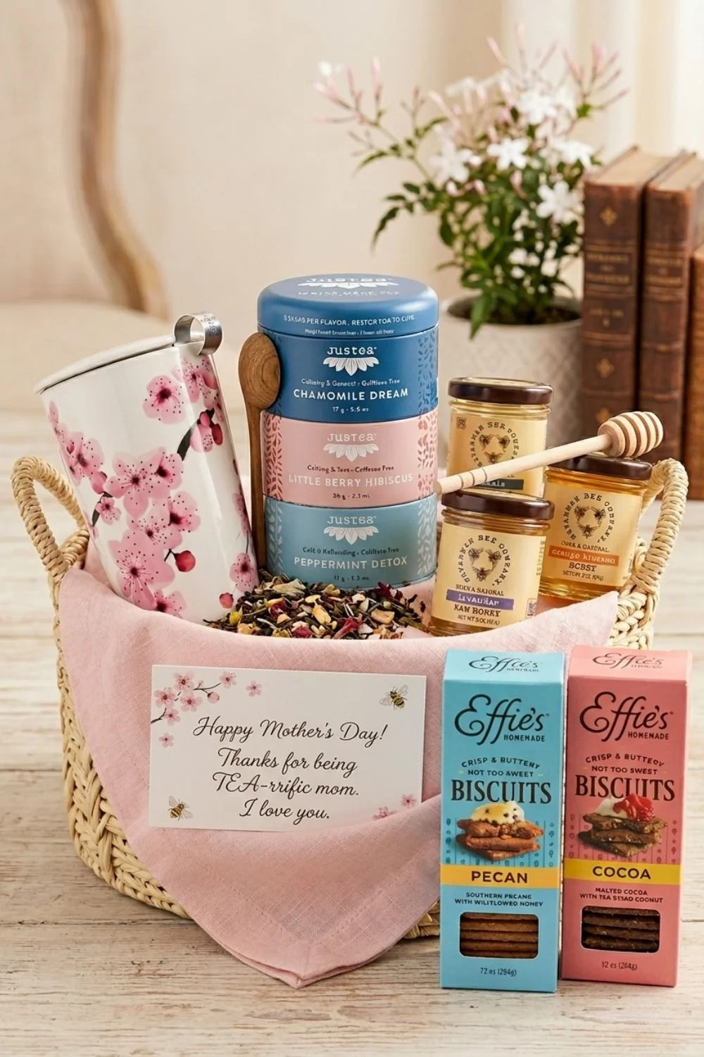 Mother's Day gift basket with herbal tea, floral mug, artisanal honey, and homemade biscuits.