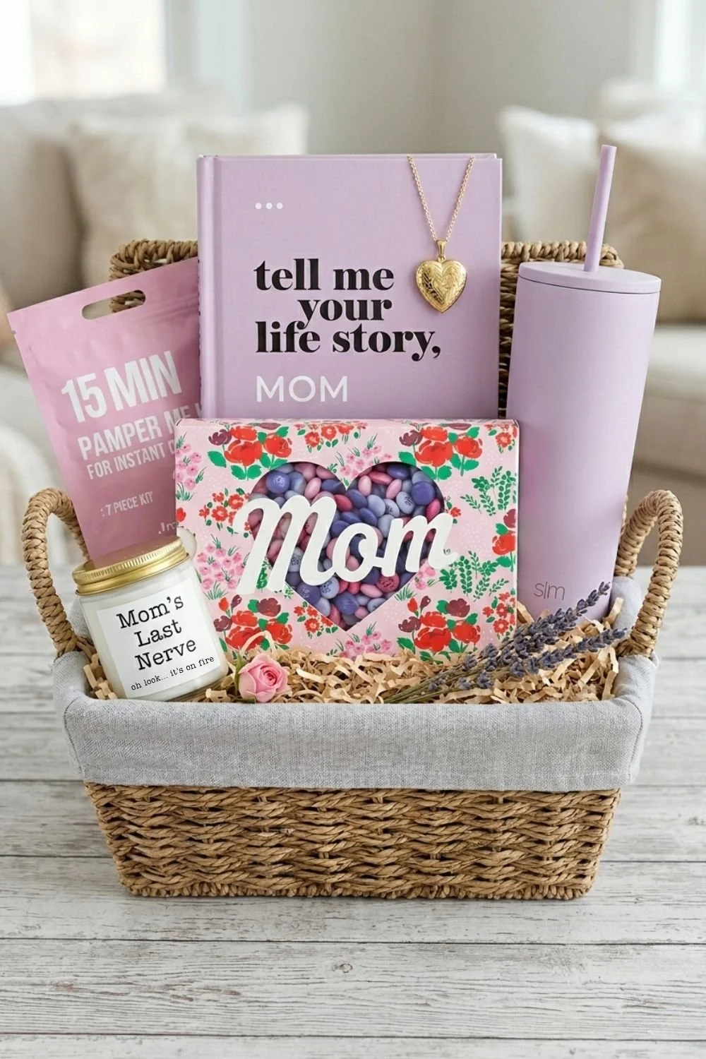 Wicker Mother's Day gift basket with pastel m&m's, gold locket, tumbler, funny candle, and journal.