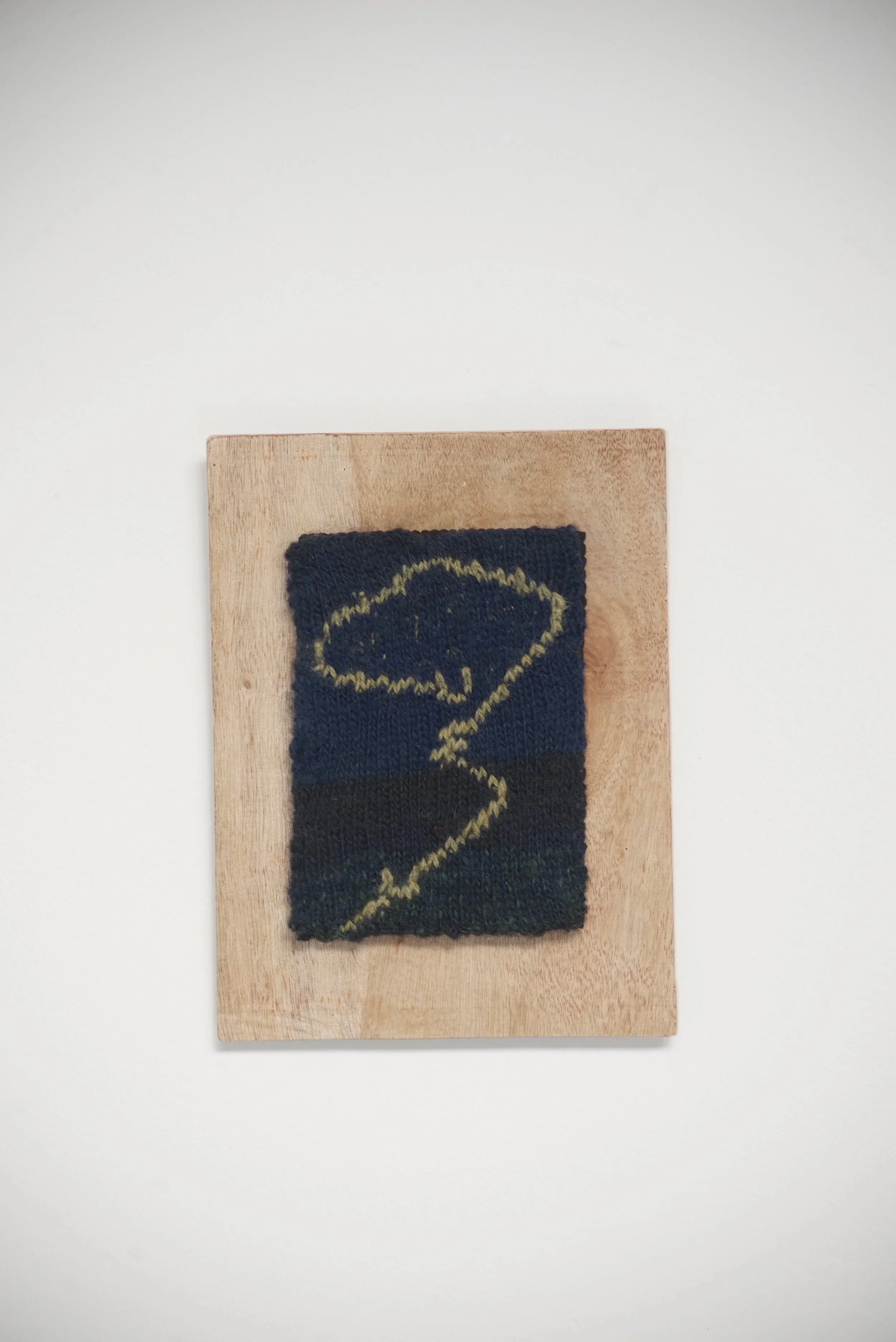 Swirl, 2025. Knitted wool mounted on wood. 7x10 inches (including frame). 