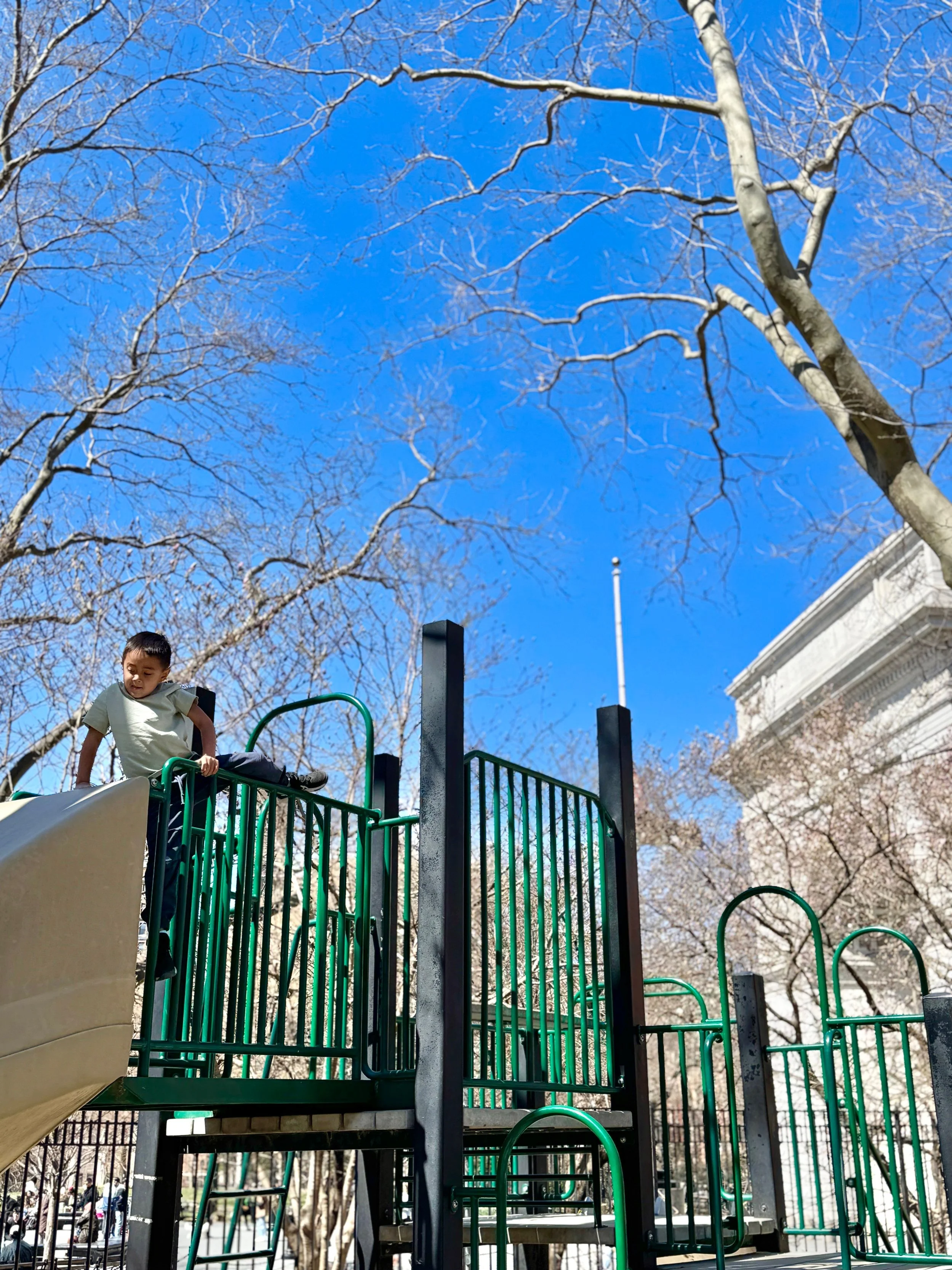 boy playing at Washington Square Park playground in NYC
