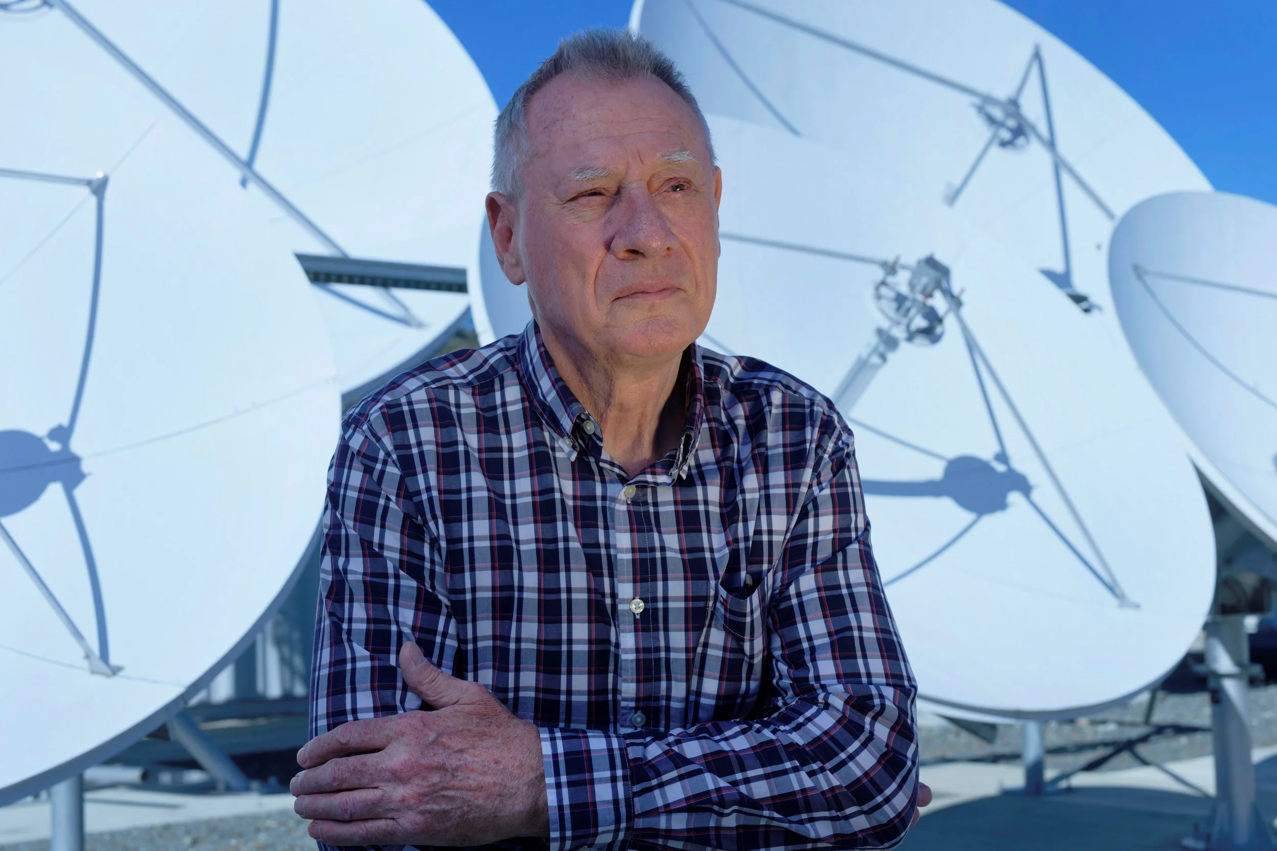 Portrait of Gateway Teleport Chief Technology Officer Keith Ramsay in front of satellite antennas