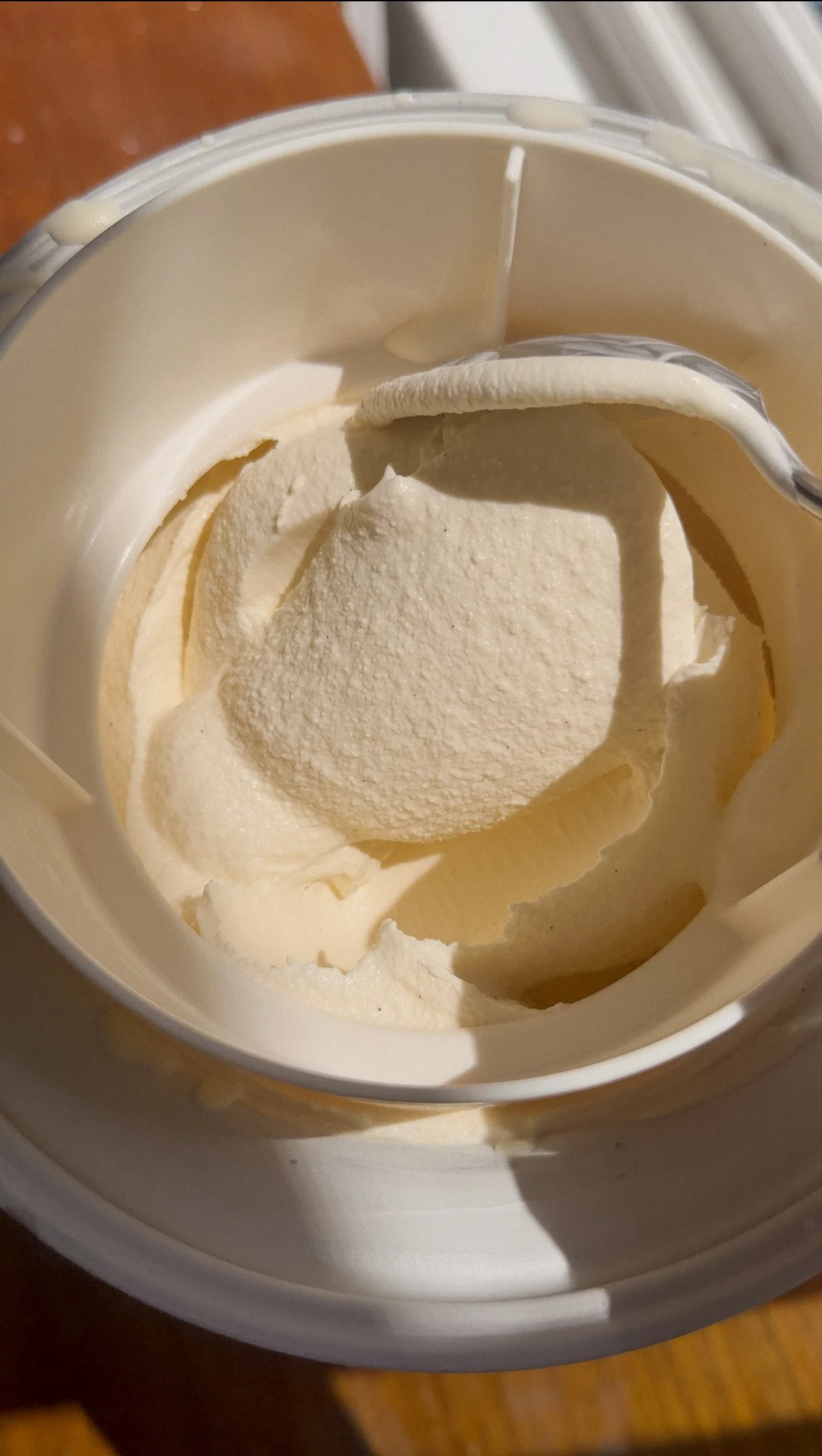 vanilla bean ice cream after being churned with the light shining on it