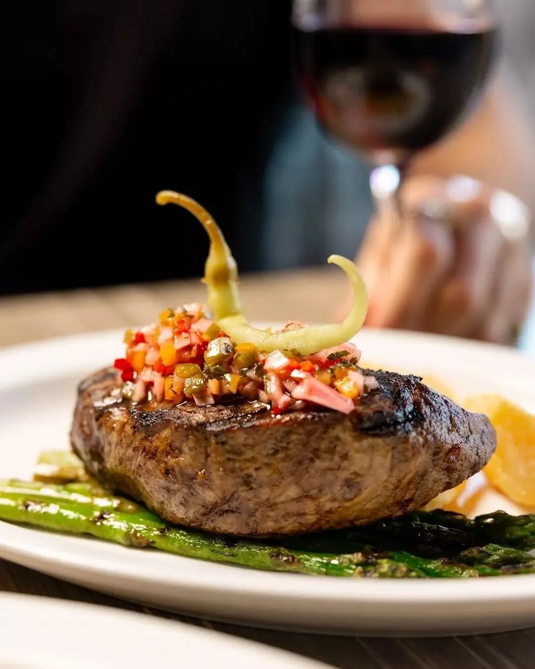 Grilled Angus top sirloin paired with crispy potatoes, asparagus and bright salsa criolla. 

#therawson #therocks