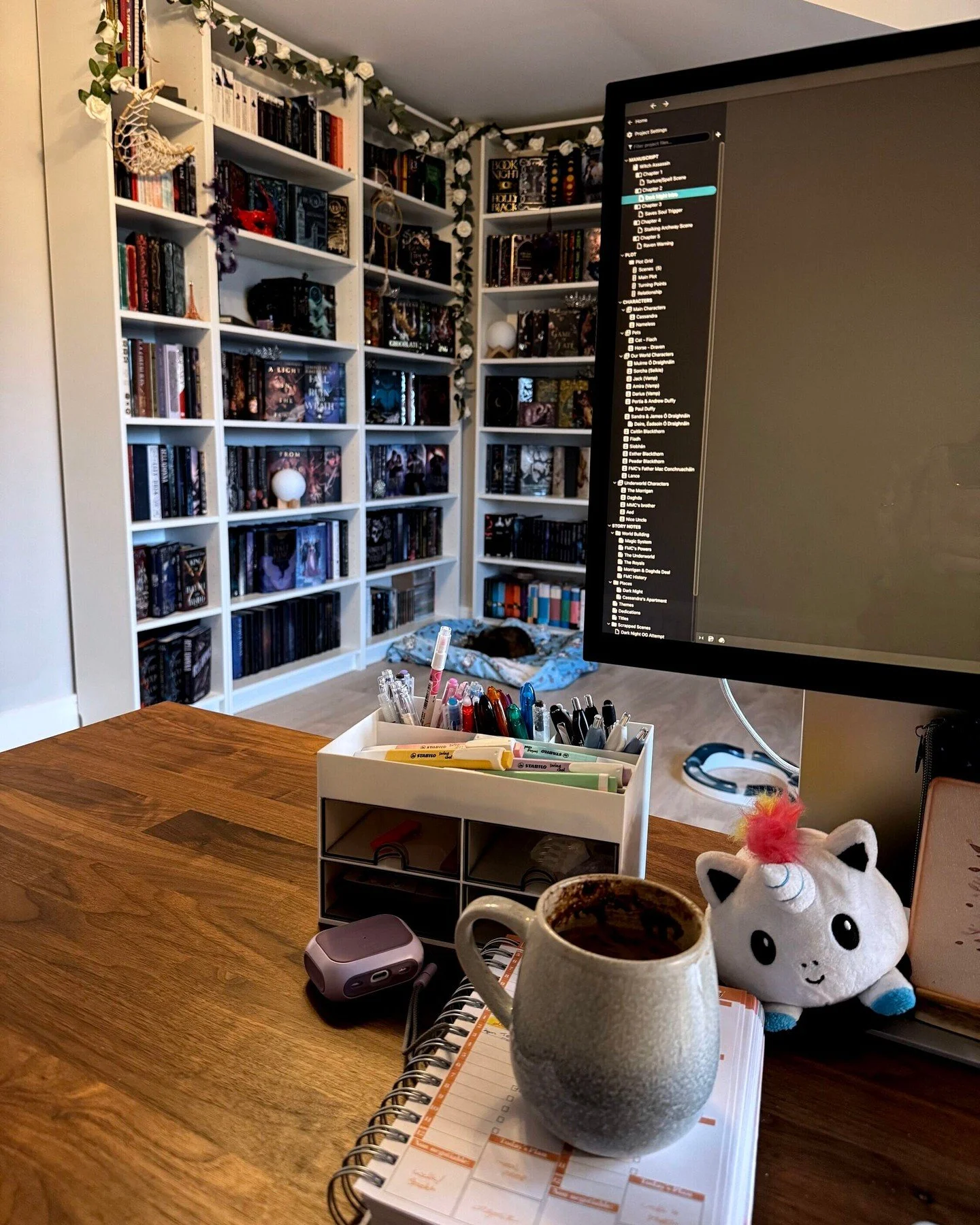 Getting away for some mid-week caf&eacute; writing time is proving impossible with all the building work going on. At least my bookcase is a pretty view while I write, even if the vibe is slightly off because my vigilante FMC is up to no good 🤣 🙊 ?