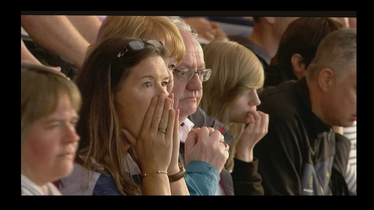 An anxious crowd watching sport looking nervous before a high pressure race