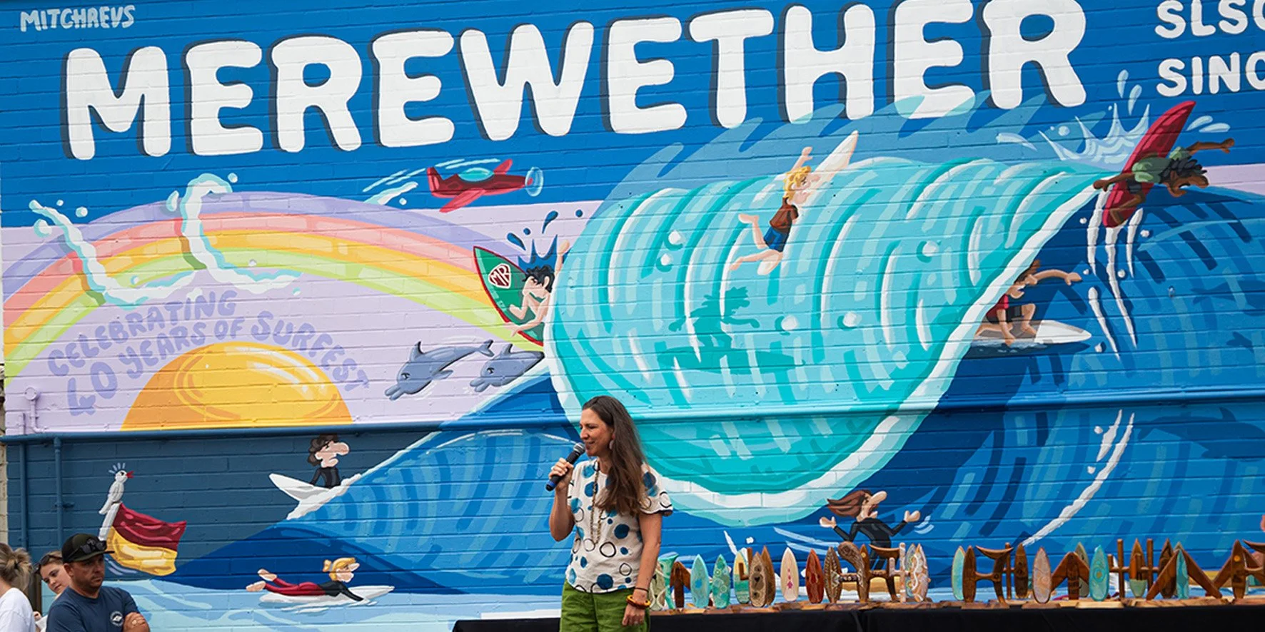 Image of a woman announcing the start of Surfest Indigenous Classic at Merewether.