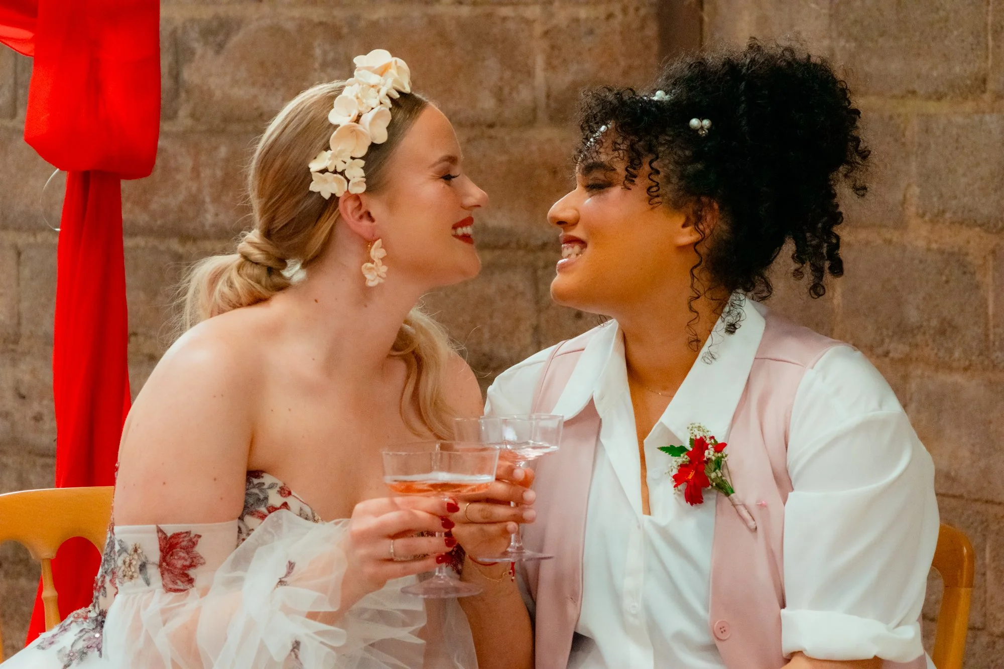 LGBTQ+ couple holding hands during toasts in Devon