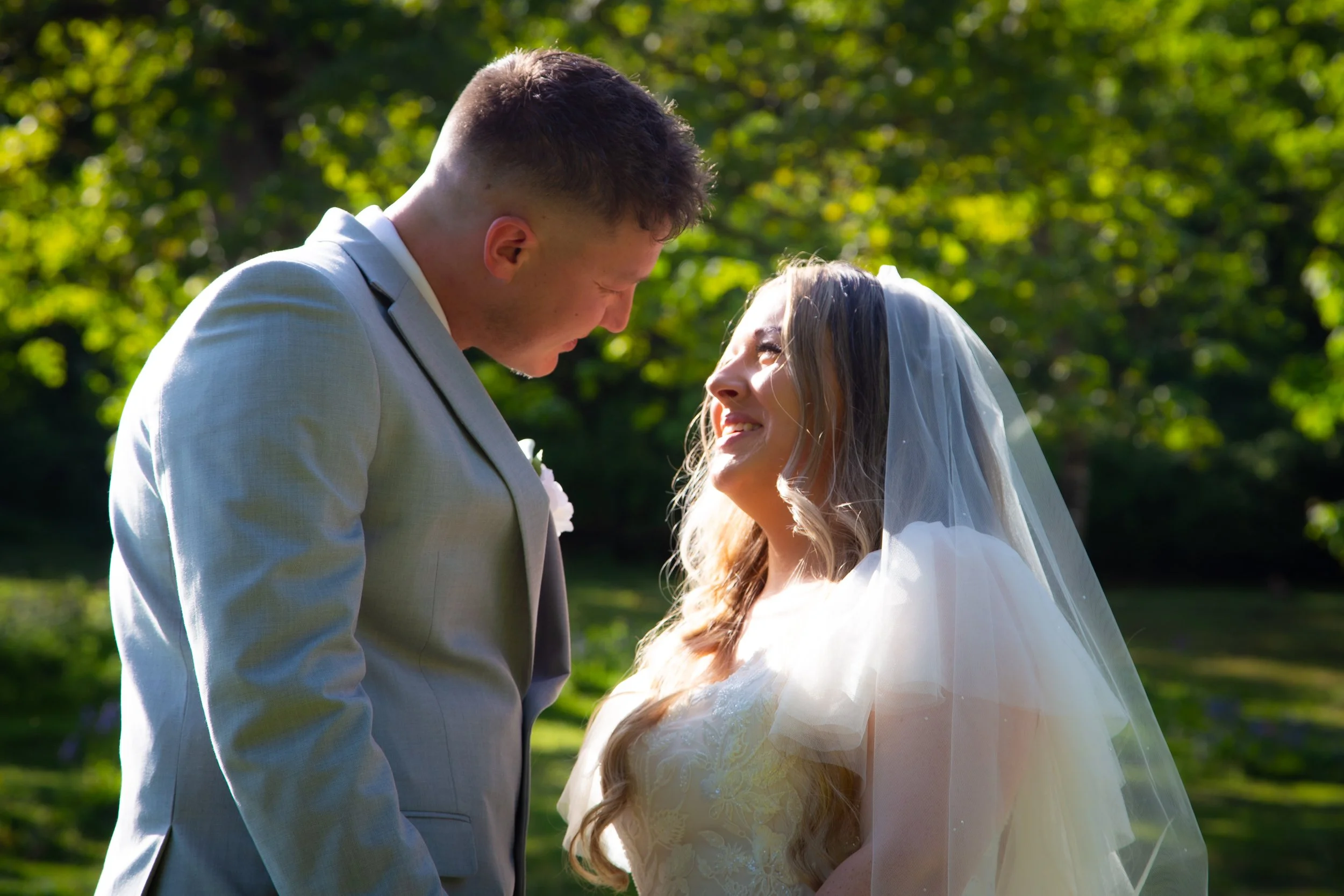 the happy couple standing amongst the beautiful grounds of Bickley Mill, Devon