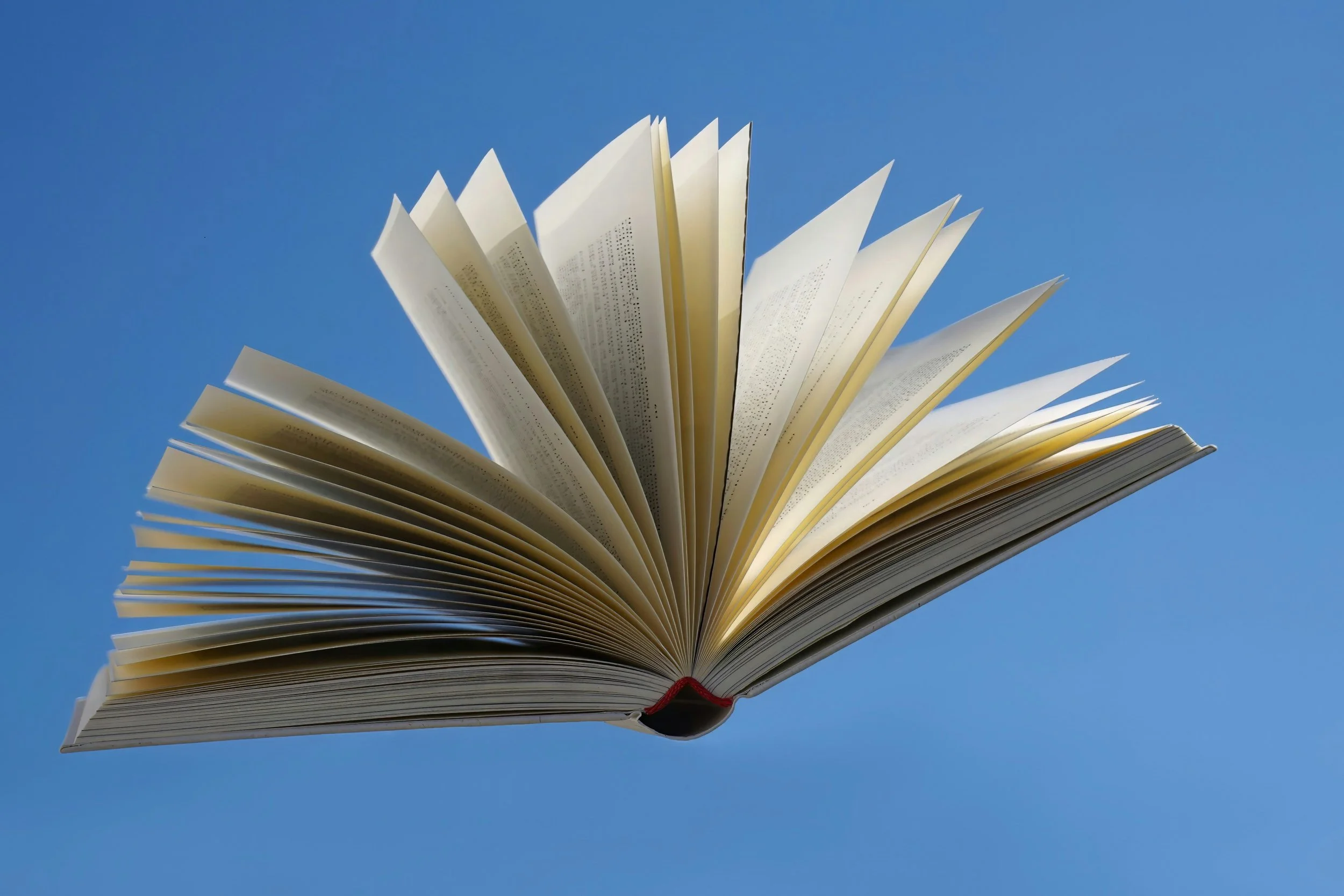 An image of an open book against a blue background