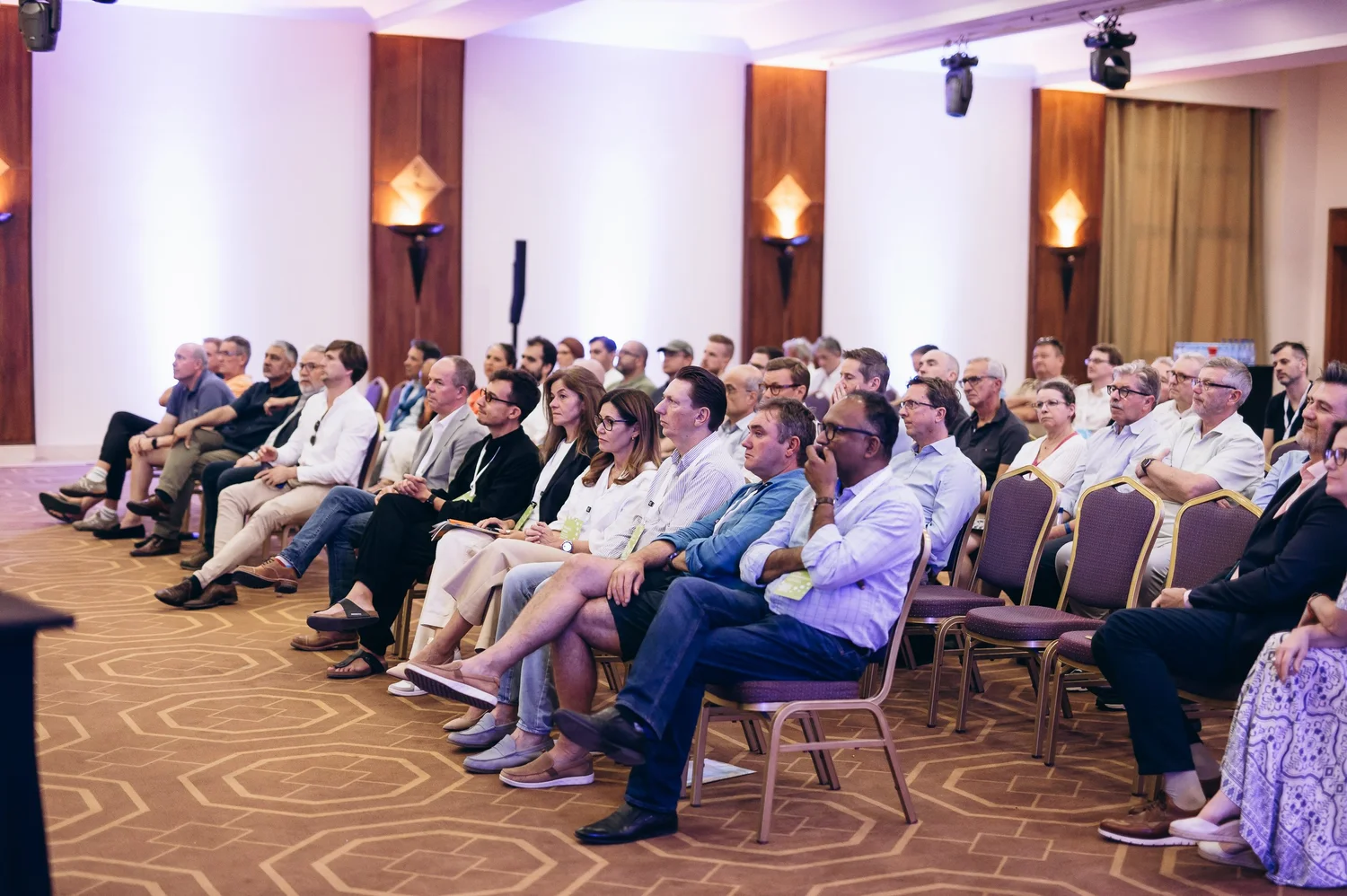 Members seated in rows at a CEO CF summit, listening to a presentation.