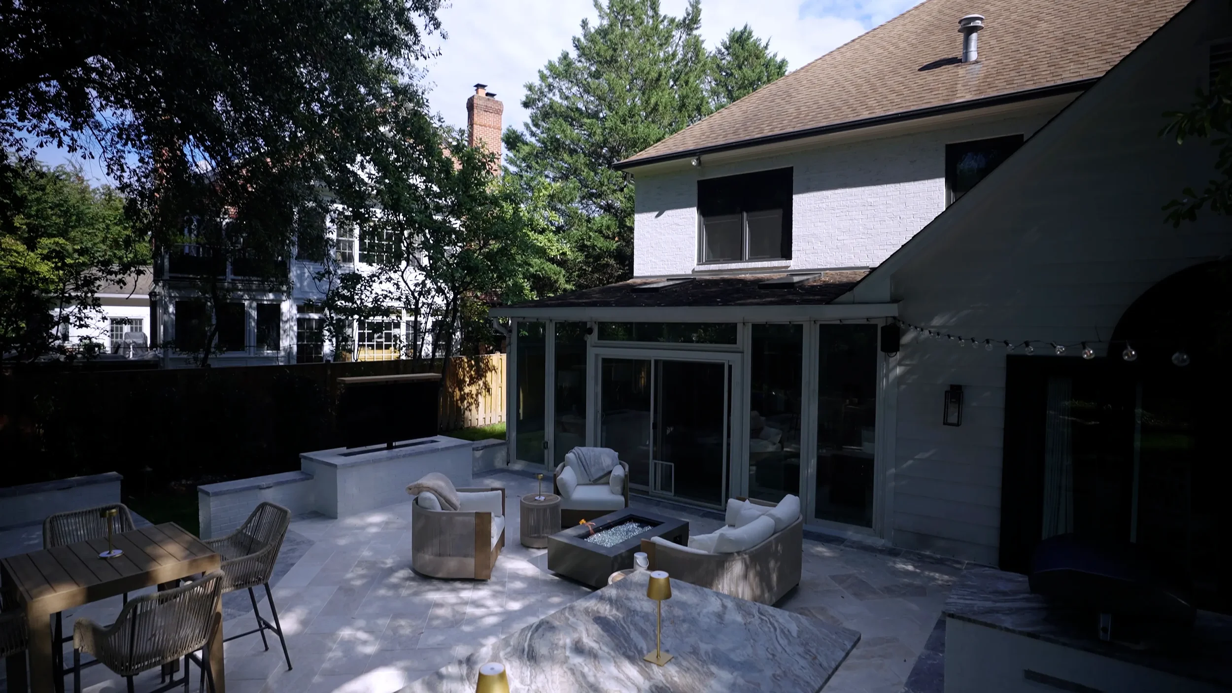 Backyard seating zone framed by layered plantings in Alexandria, VA