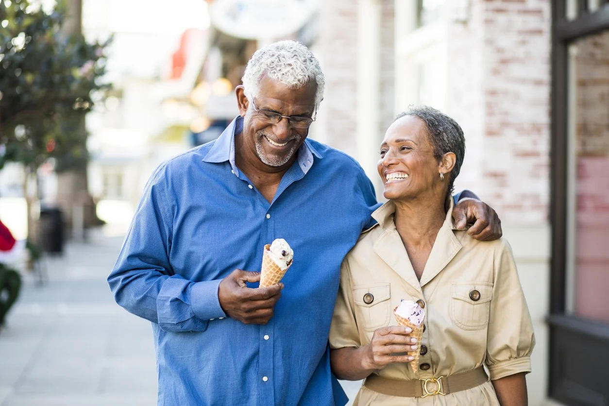 Smiling older couple enjoying ice cream and a walk together—showing how quality time repairs trust and closeness in relationships.