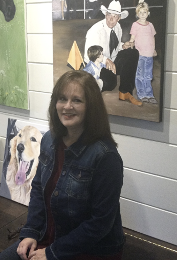 Ronda Williams at artshow with her paintings of Dogs and a family at the Rodeo Painting