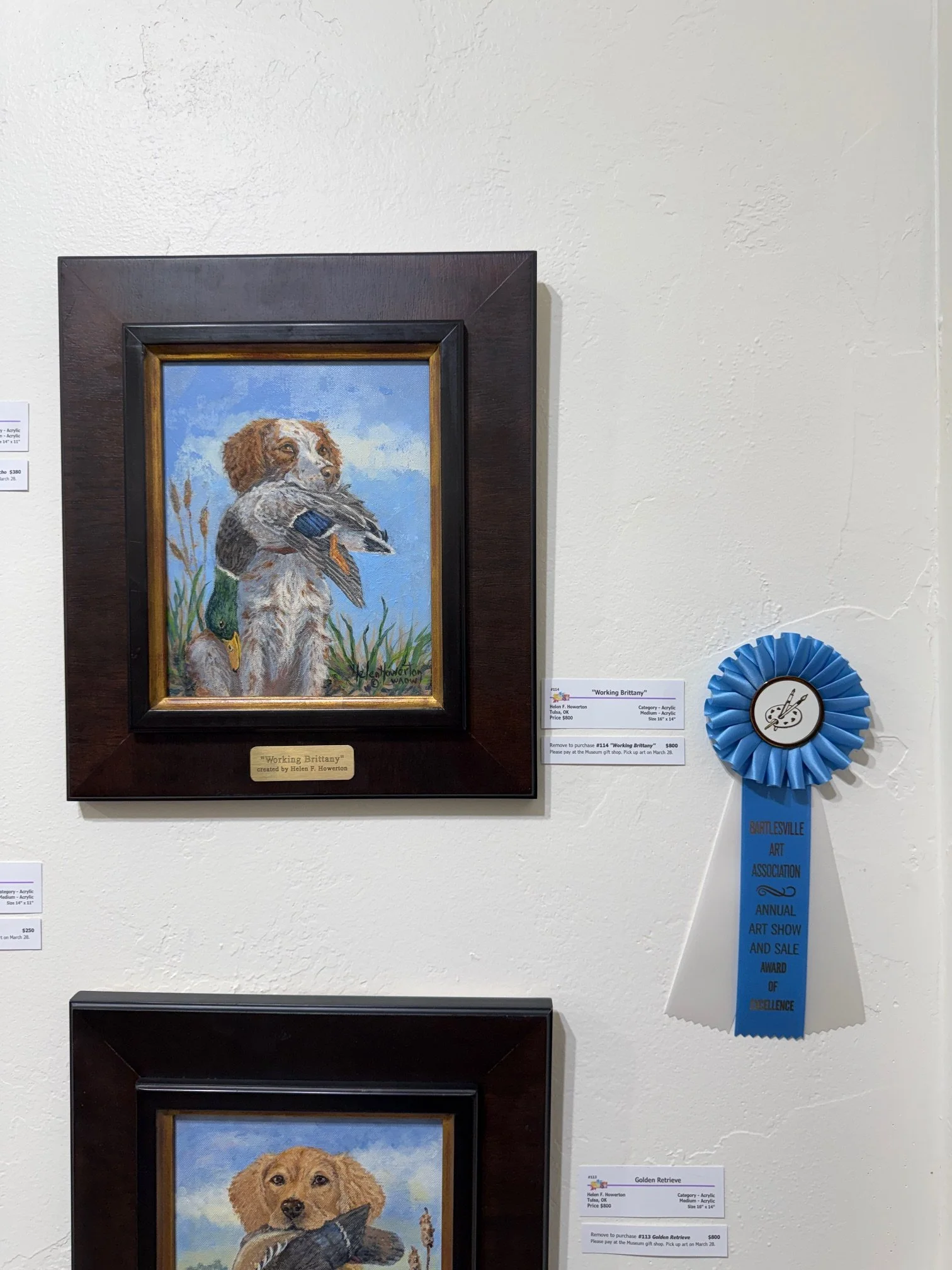 Painting of a Dog on a hunt with a Duck in it's mouth by Helen Howerton at the Bartlesville Art Association at Woolaroc Museum The Bunkhouse