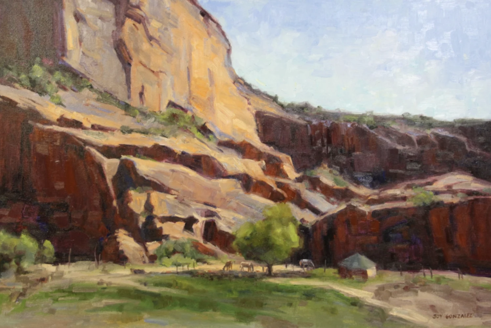 Beautiful Canyon Area with soaring walls and green patches of grass and trees. Also a small home in the canyon with horses grazing by Joy Gonzalez.