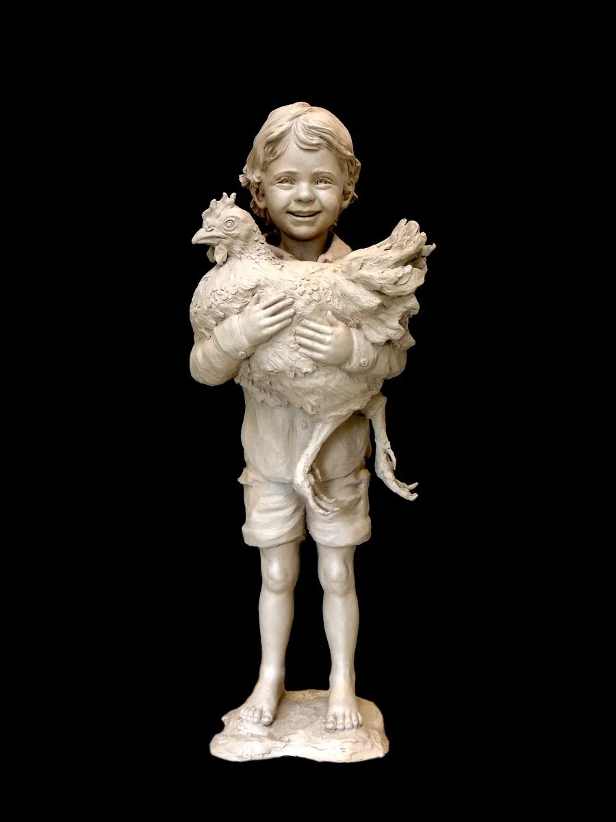 sculpture of young boy holding his chicken