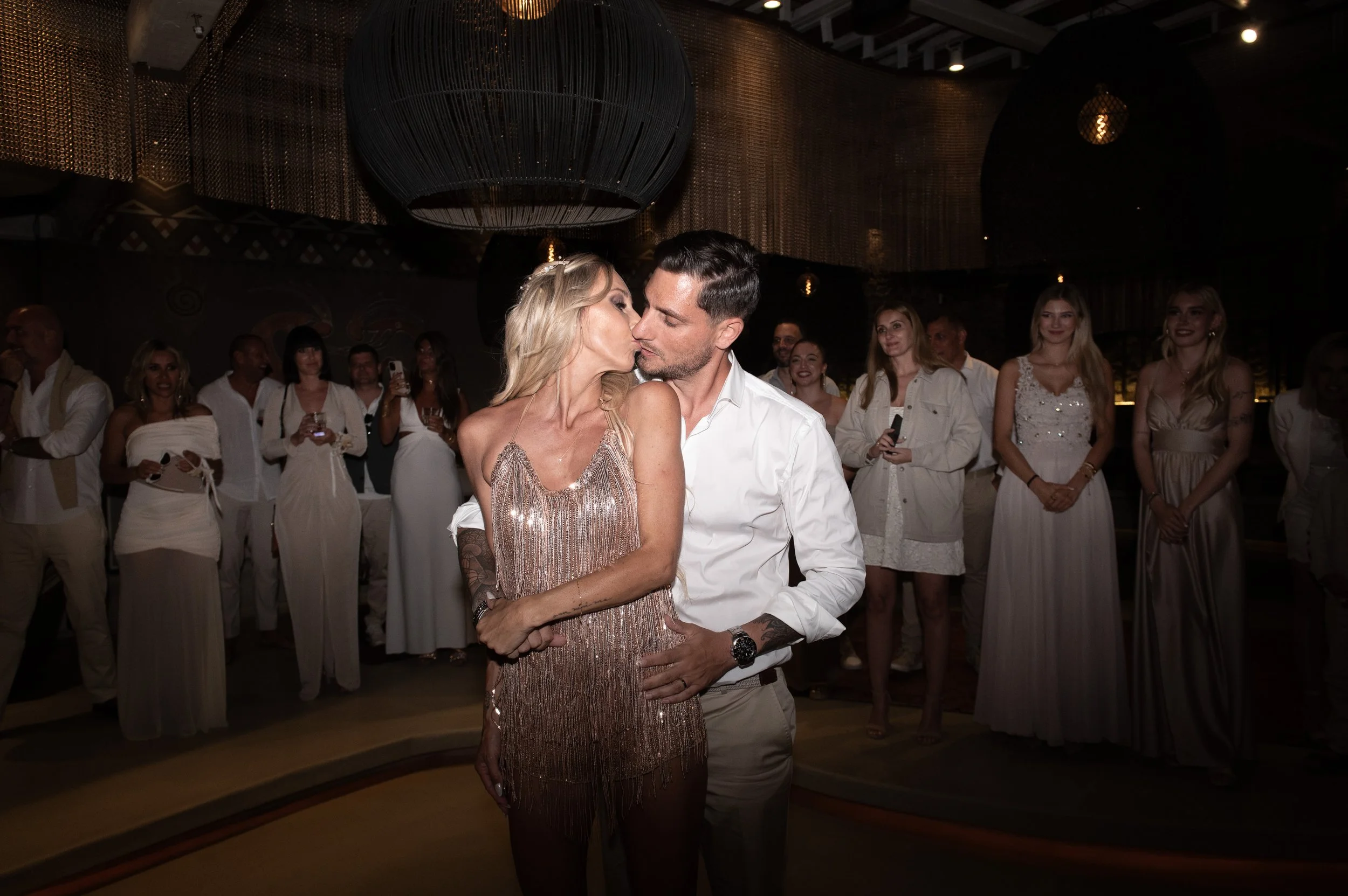 Couple kissing on the dance floor during their destination wedding celebration in Mykonos, Greece