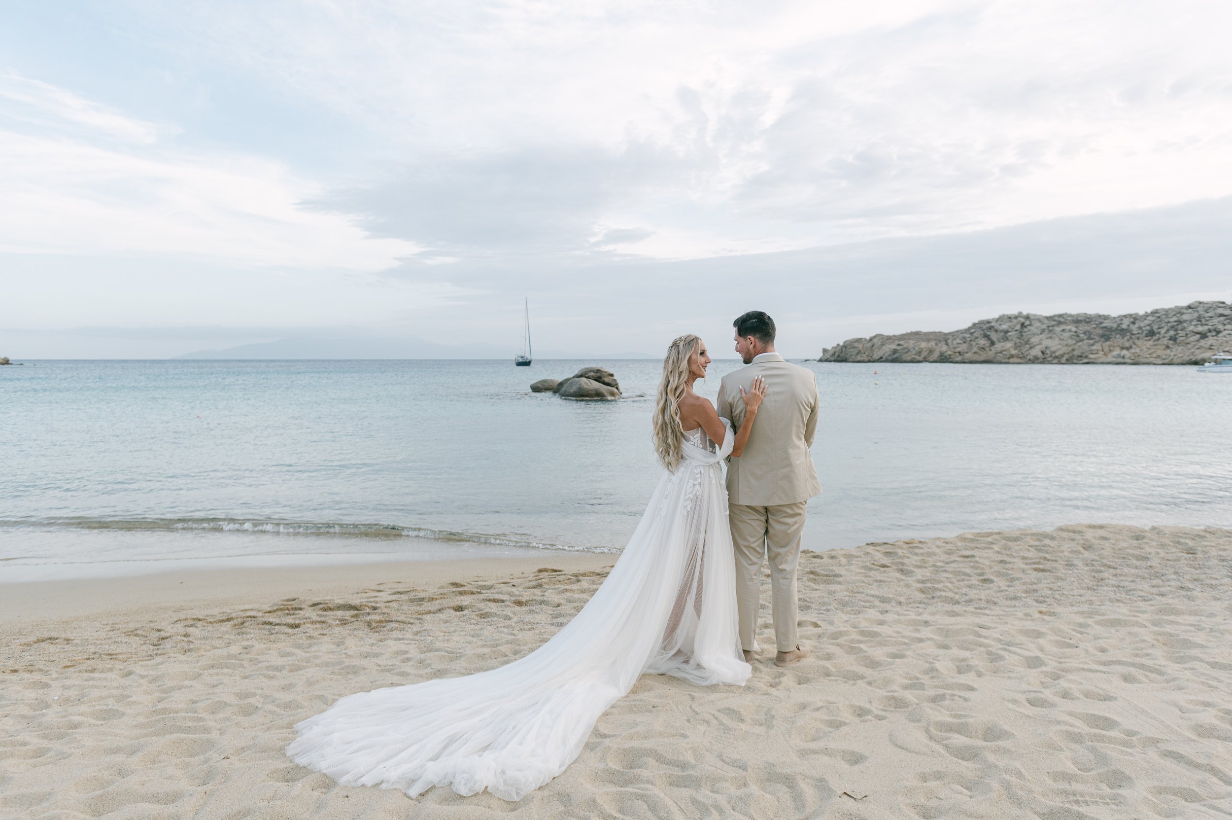 Bride and groom on the beach during their luxury destination wedding in Mykonos, Greece