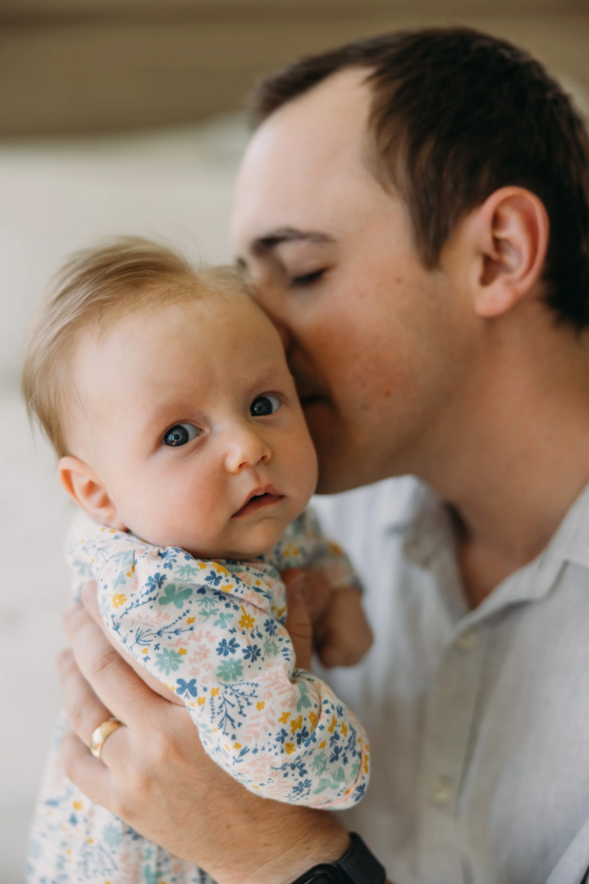 nashville-newborn-session-parents-kissing-baby.jpg